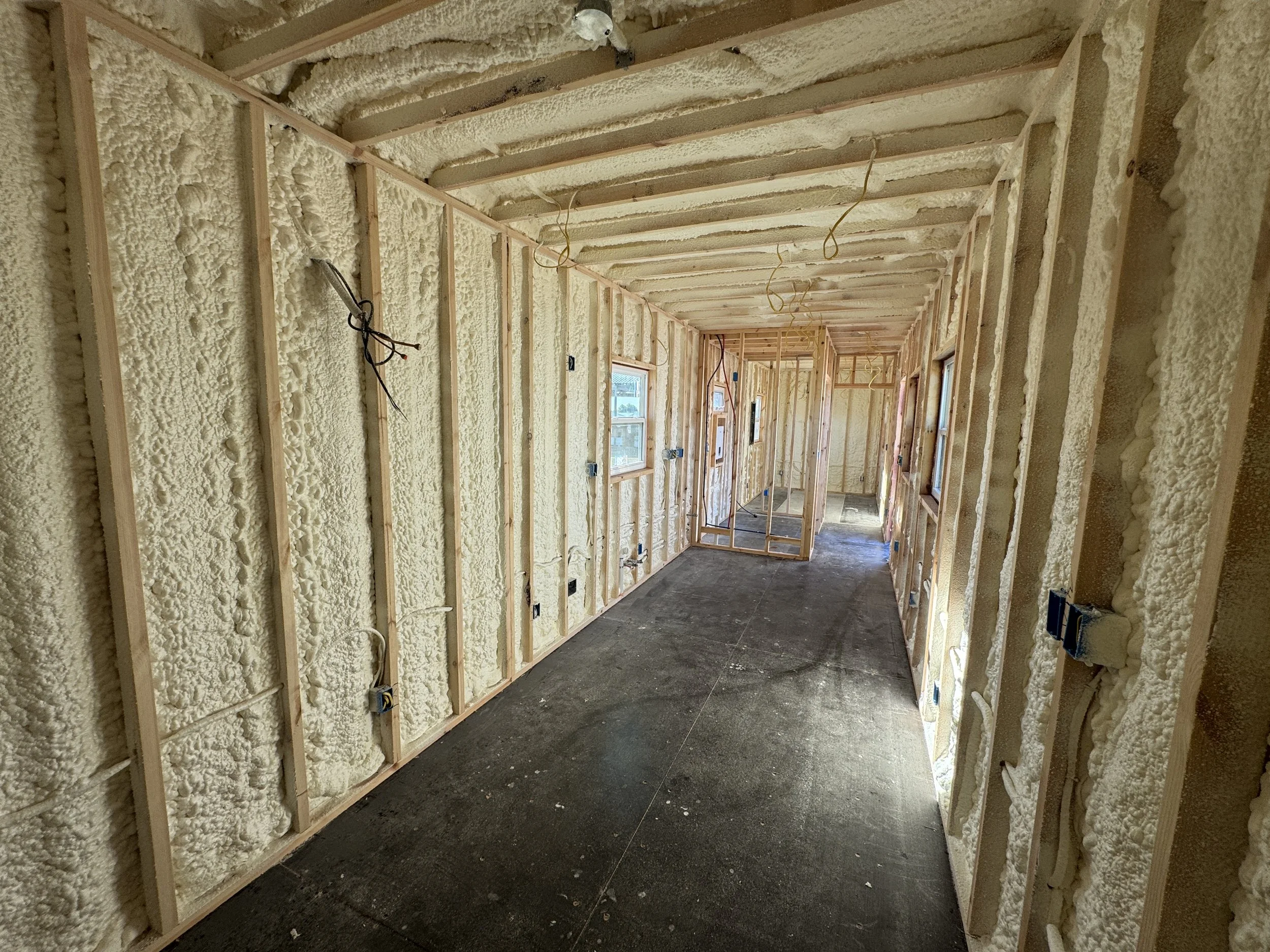 Spray foam insulation inside our 40’ high-cube shipping container home build in Paris, Texas – part of our $65,000 fully finished turnkey model