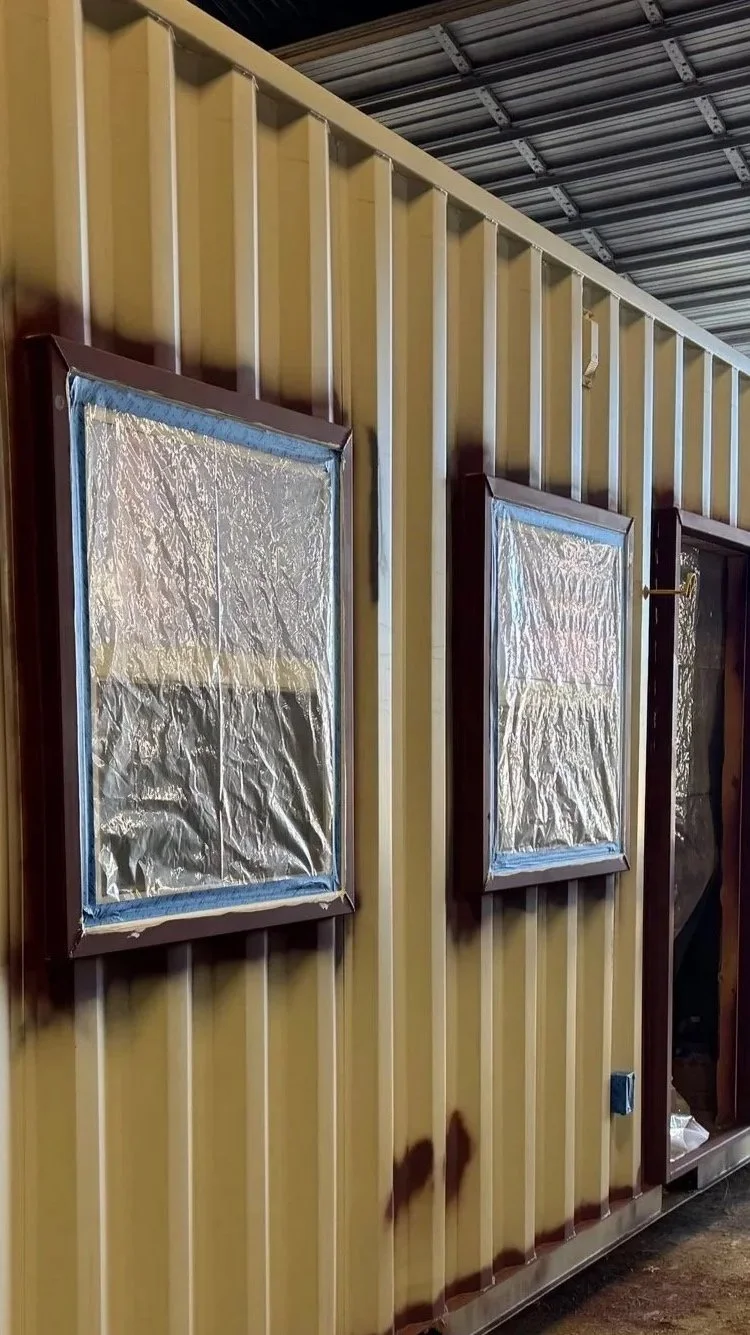 Reflective insulation and windows installed during construction of our 40’ high-cube shipping container home in Paris, Texas – part of the $65,000 fully finished turnkey model