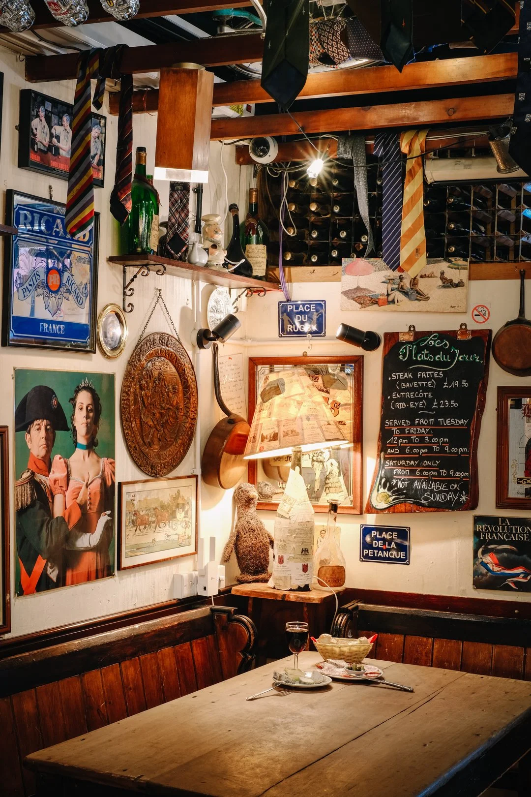 Cozy interior of our Soho wine bar featuring candlelit tables and traditional French bistro decor.