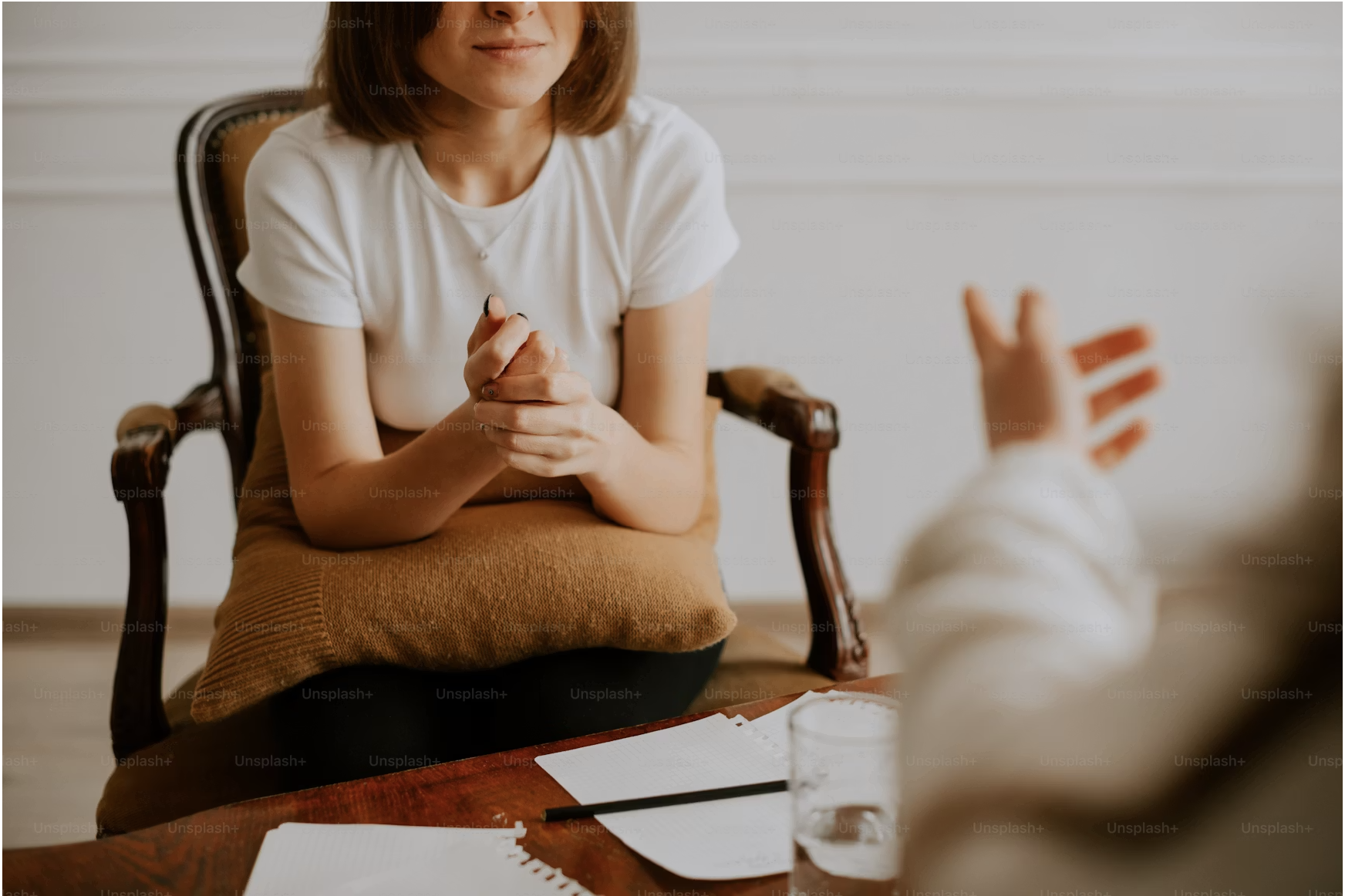 A woman sitting in a chair in a therapy session.