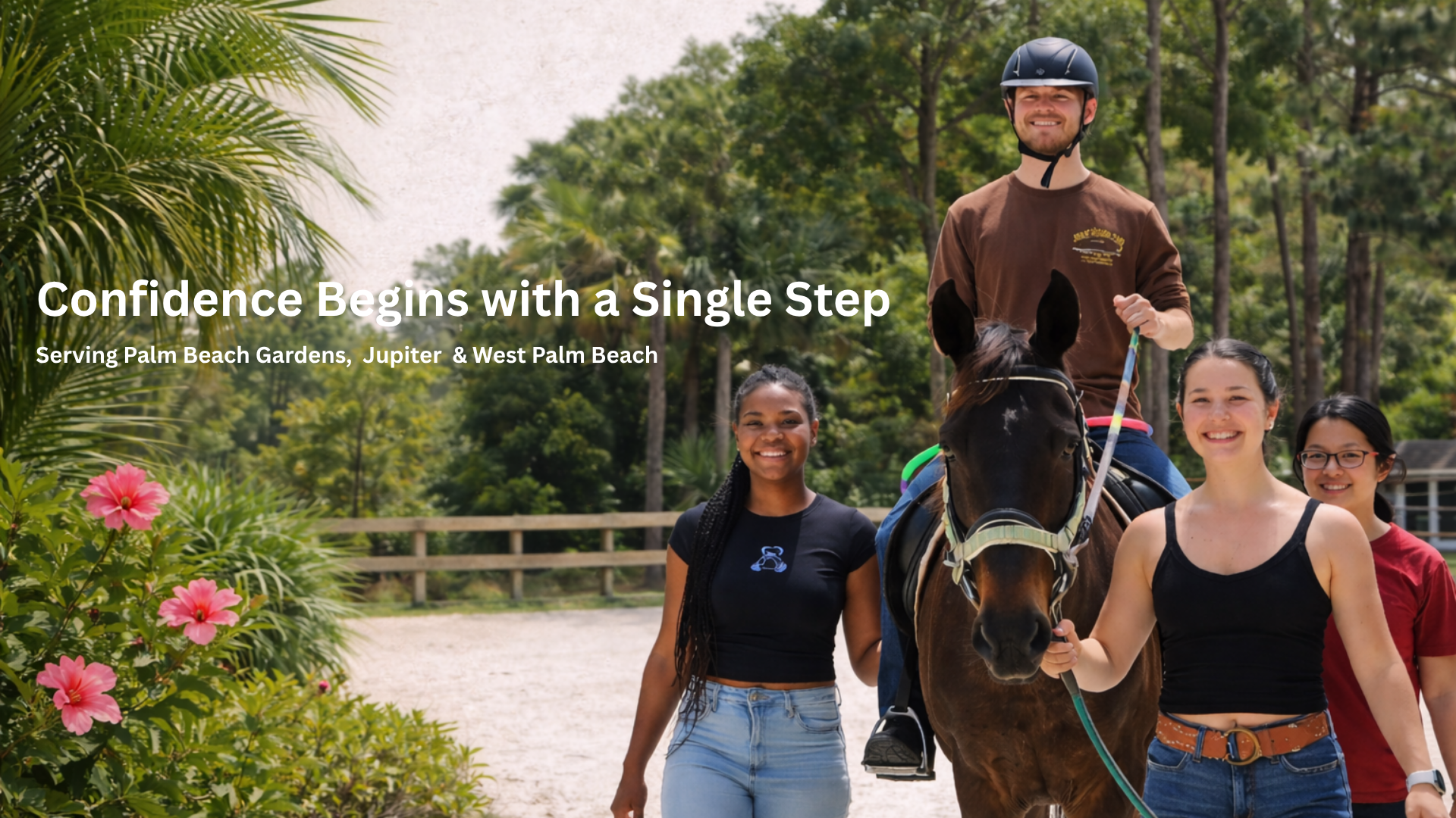 A group of four people, including a man riding a horse and three women walking beside, outdoors in a lush park with green trees and pink flowers, smiling and enjoying a sunny day.