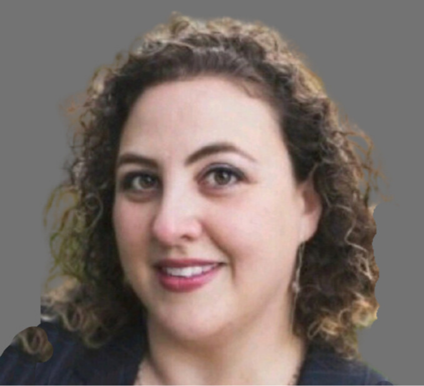 Portrait of a woman with curly brown hair, wearing earrings, smiling, with a gray background.