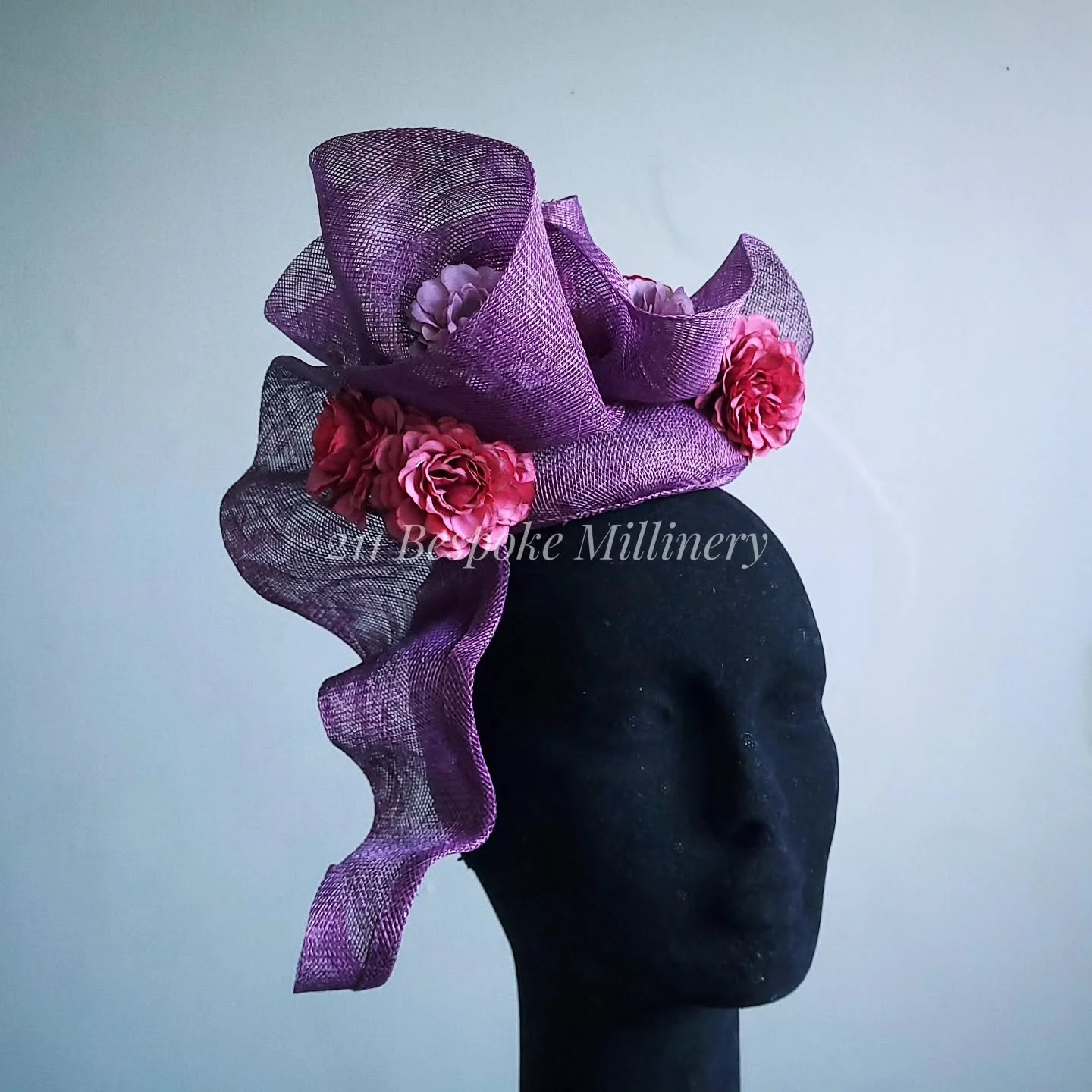 It may be a pinch obvious that this is my favourite new design for 2025! 🥰

A gorgeous deep plum toned purple coloured sinamay, hand blocked, hand shaped and steamed into elaborate curls and spirals which drape off the side. 

Fun fact ~ The hand st
