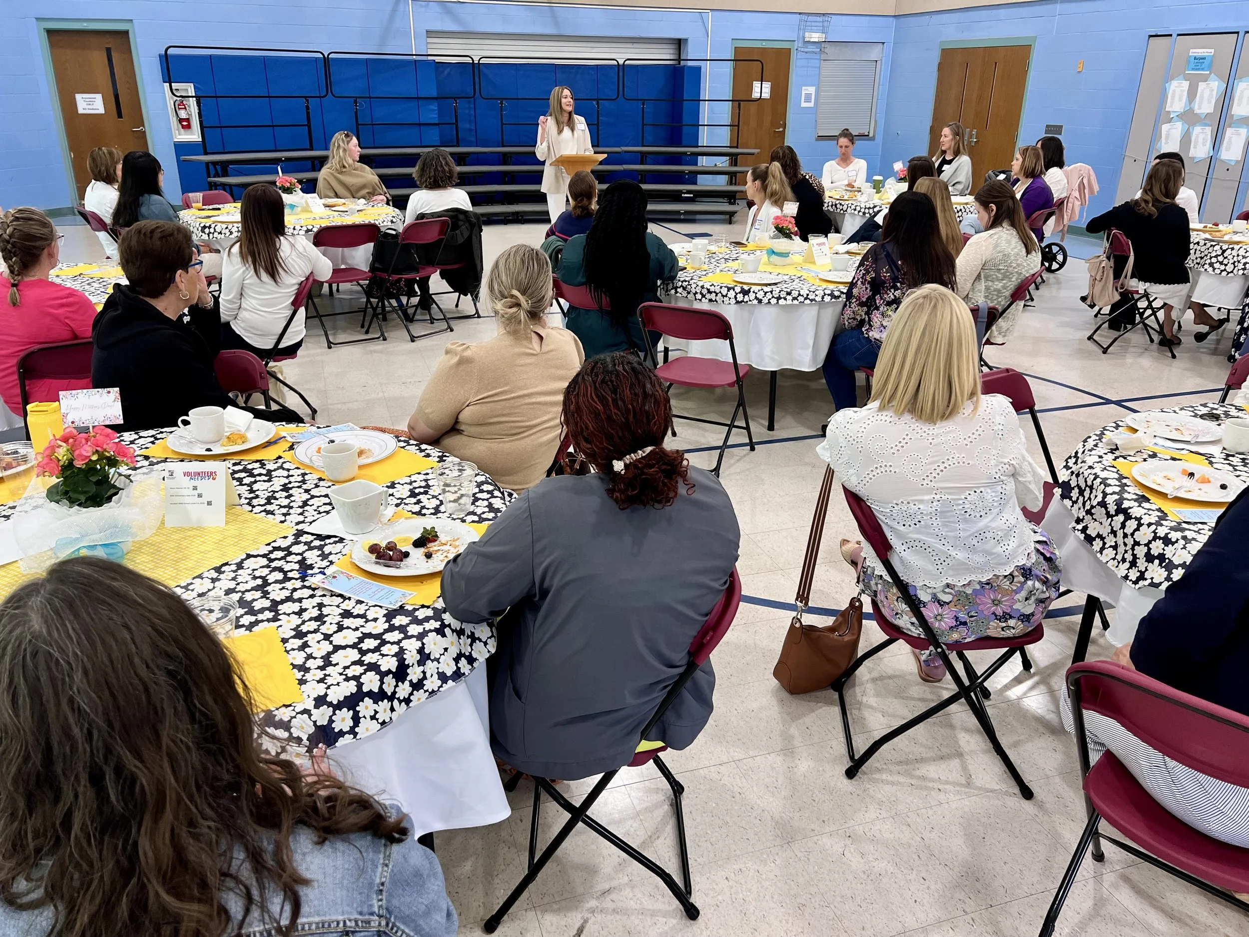 Author Julie Yost speaking to a large group at a parish event.