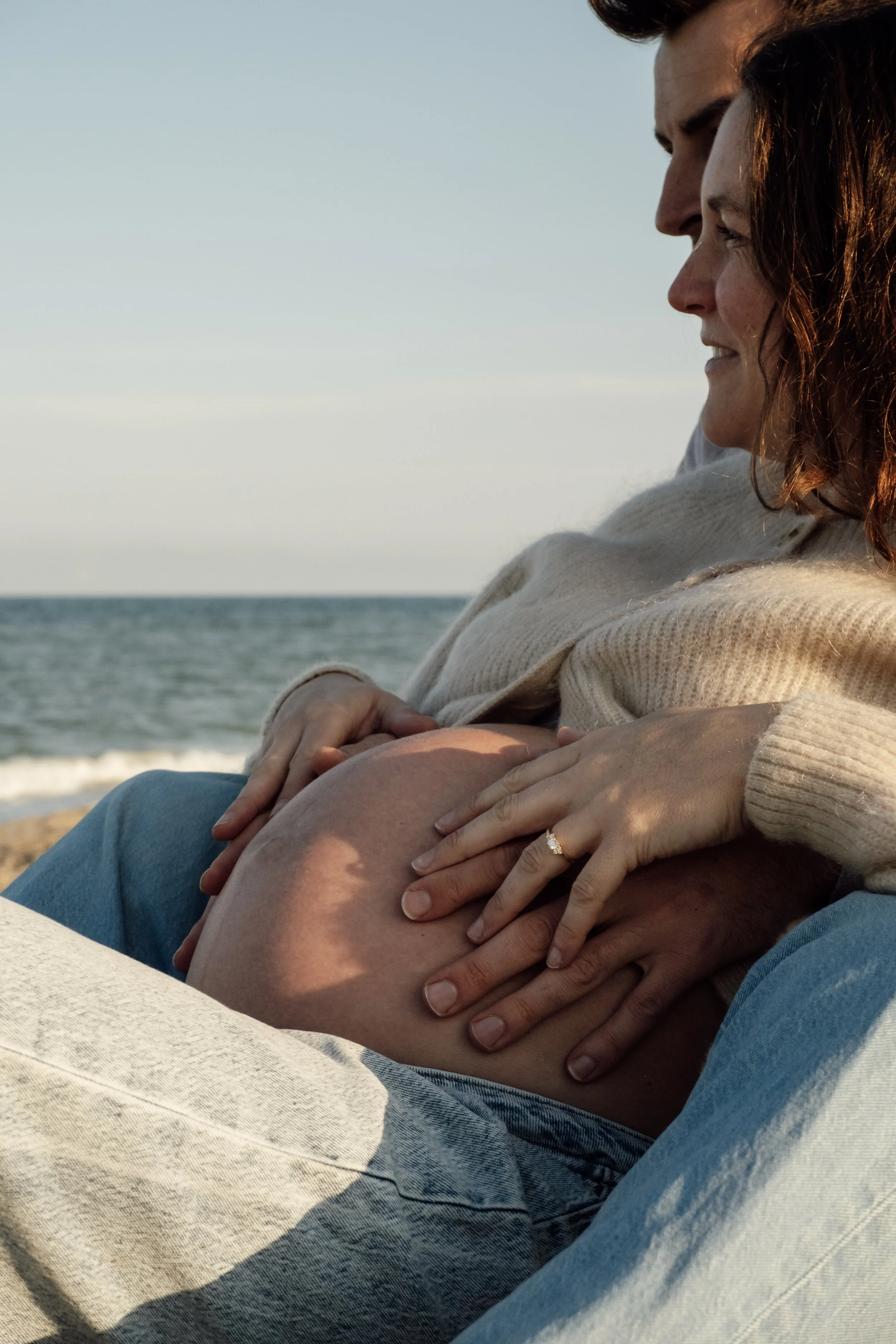 Parents to be with hand around the pregnant belly