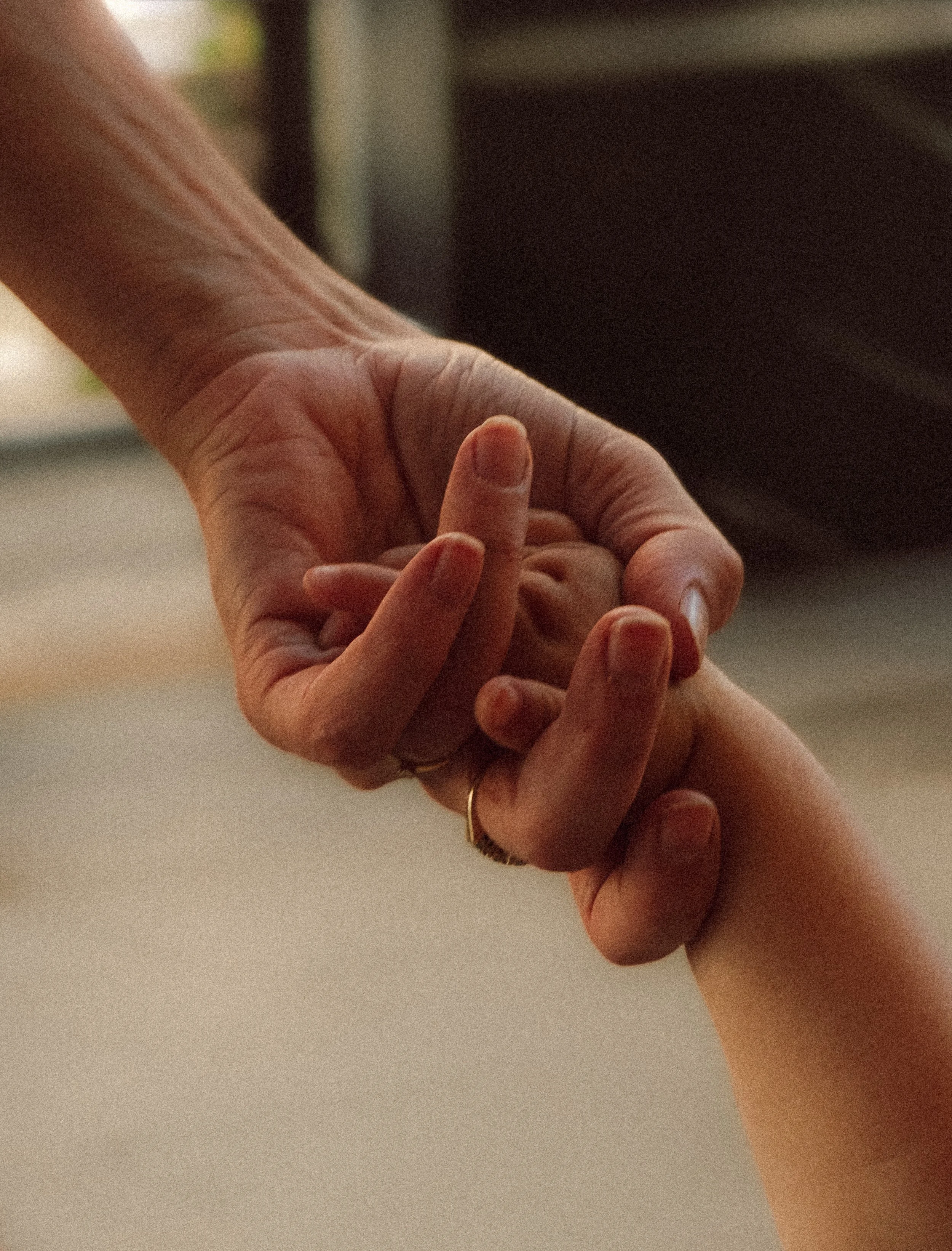 Close-up of a person fastening a ring on another person's finger.
