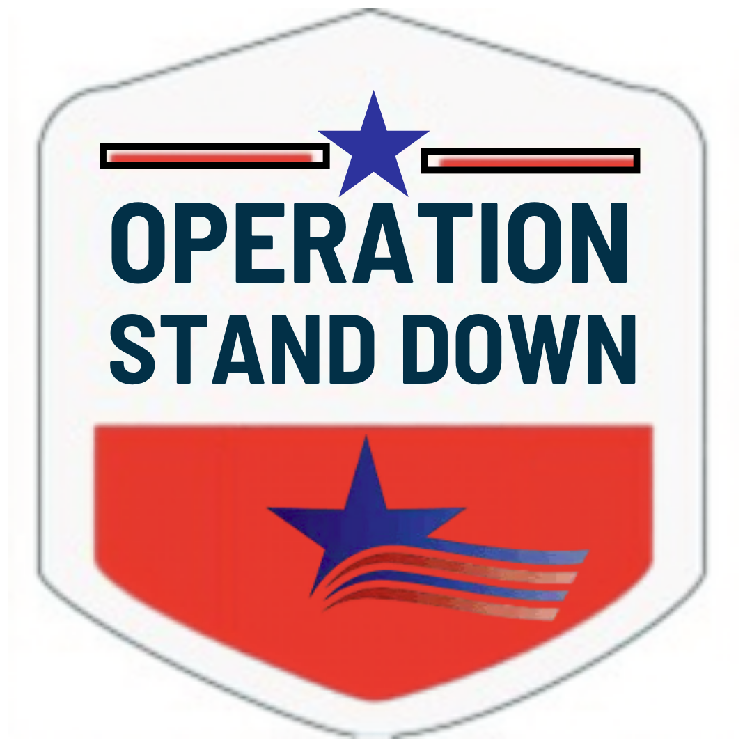 A badge with a white background and a red bottom half featuring a blue star with red and white wavy lines. The top half has the words 'OPERATION STAND DOWN' in bold, dark blue letters, and there are two red lines with white borders and a blue star in between at the top.