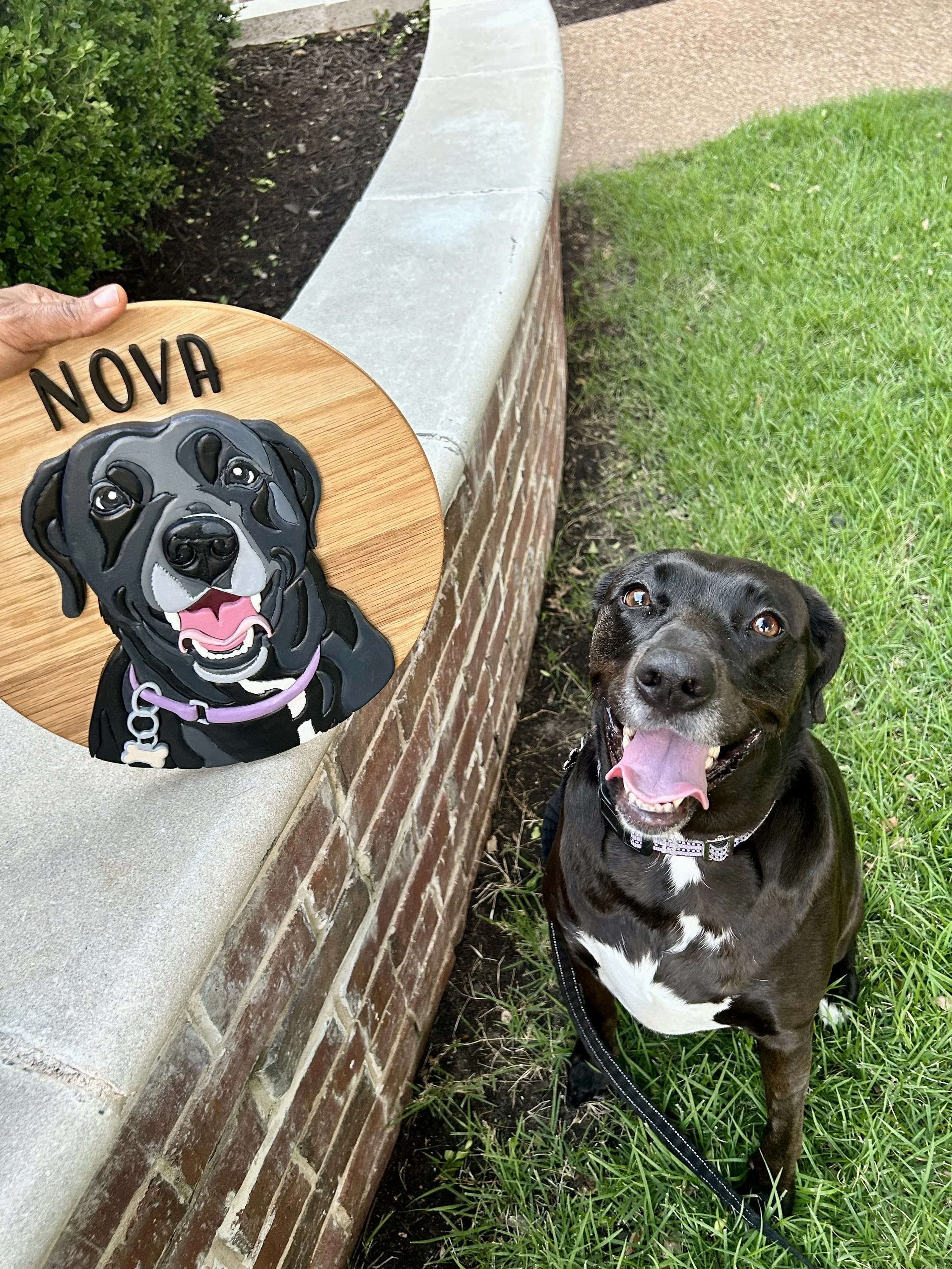 Image of dog with a wooden sign of the dog next to the dog.