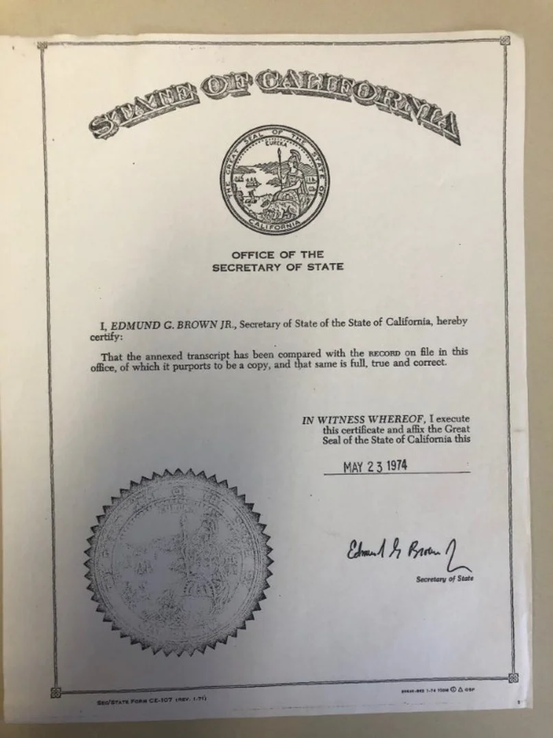 Official California state document dated May 23, 1974, with the seal of California, signature, and text certifying a transcript comparison