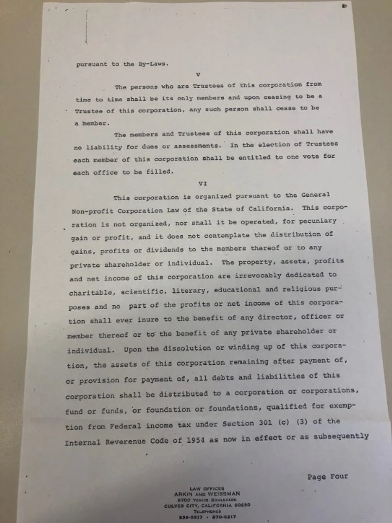 A scanned legal document with typed text, containing law-related clauses about trustees, corporate organization, liabilities, profits, and dissolution procedures, ending with the law office information at the bottom.