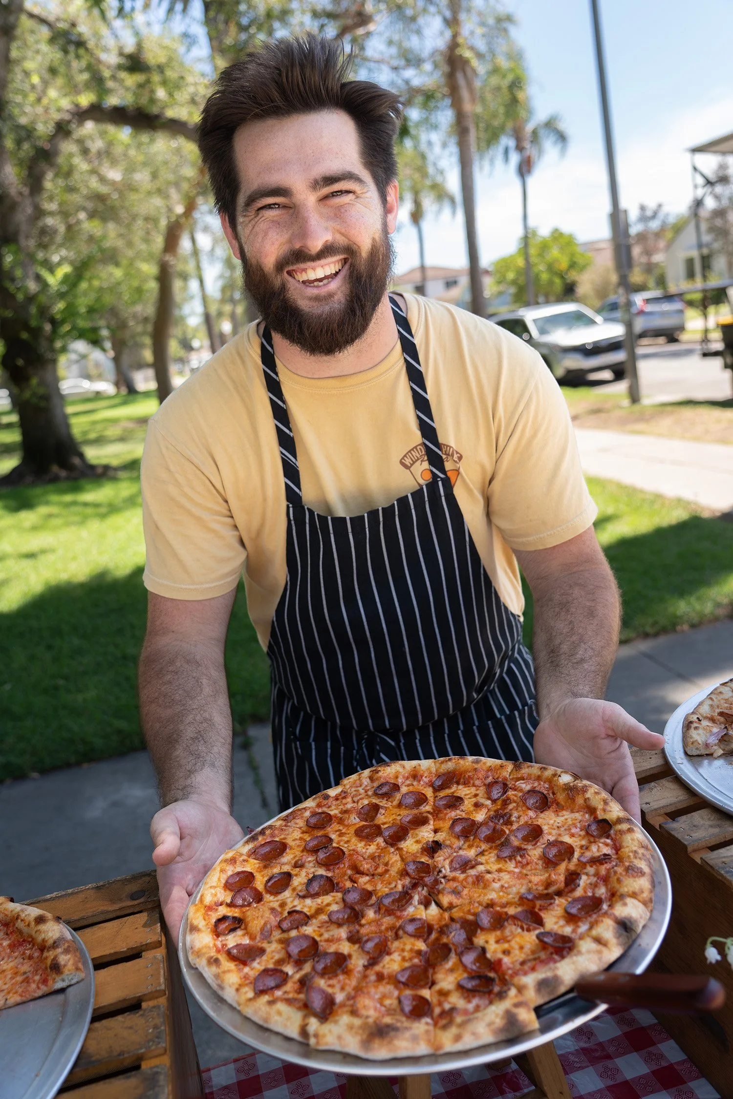 Windsor Hills Pizaa Chef serving up the pizza.jpg