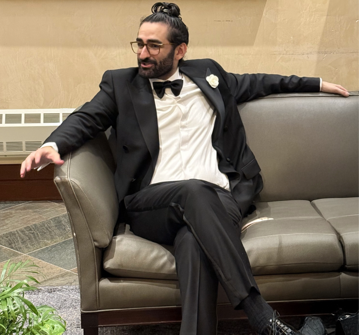 Abdulla AK ALMoumen Creative Director and Content Strategist based in Houston Texas seated in a tuxedo