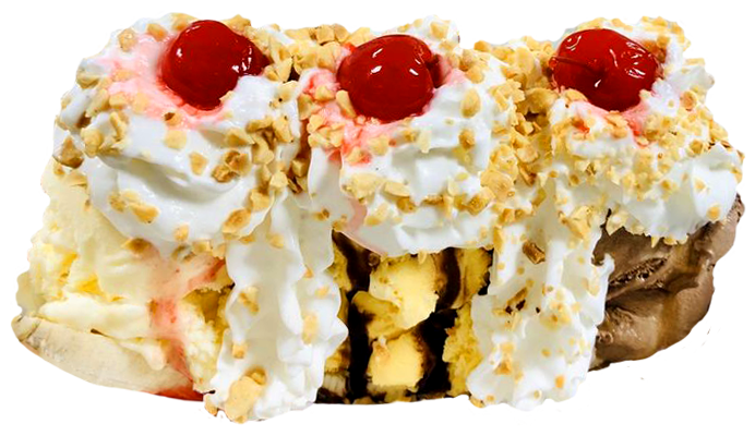 Close-up of a dessert with whipped cream, cherries, chopped nuts, and chocolate and vanilla ice cream inside a waffle cone.
