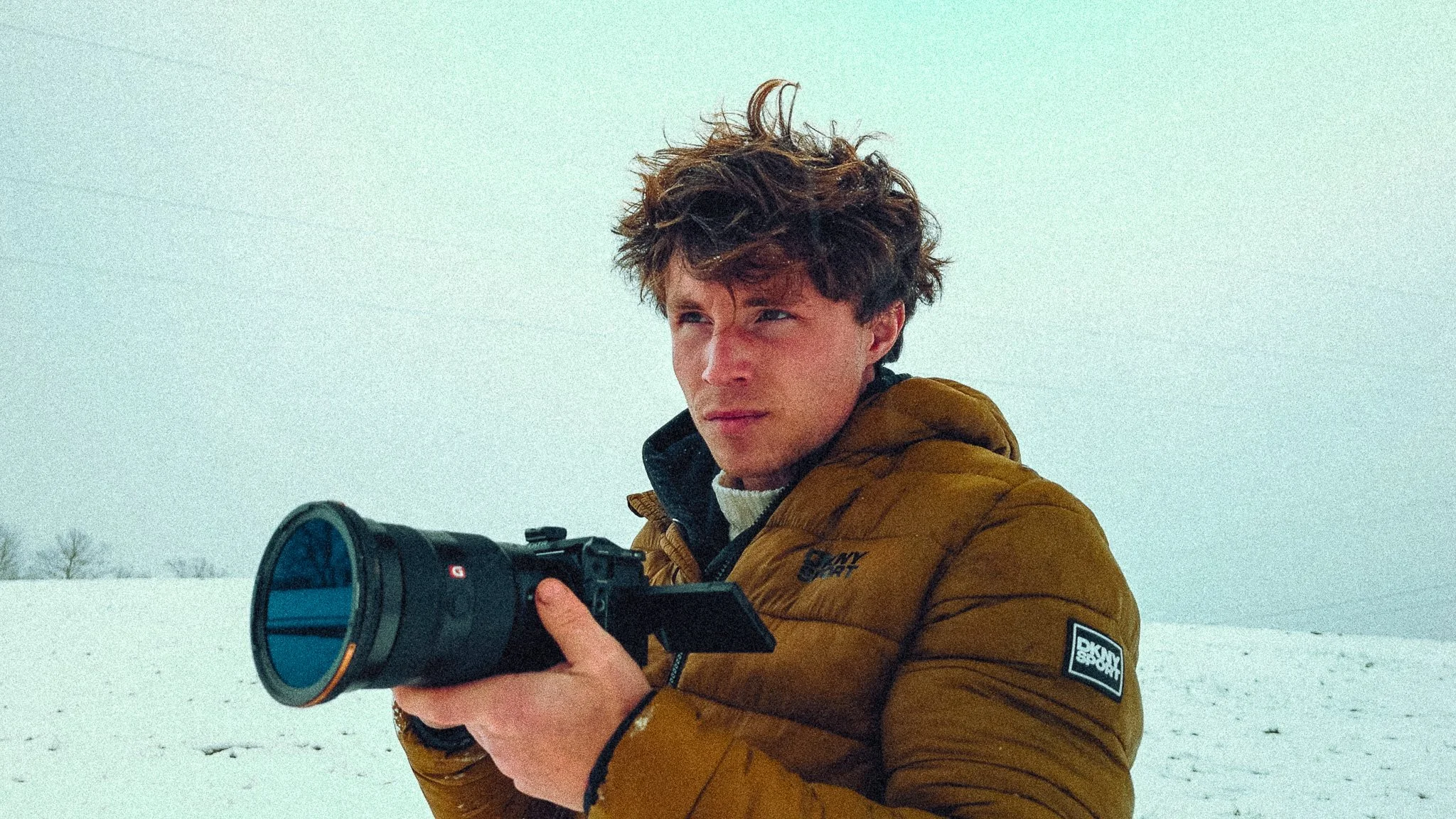Shane Johnson holding a cinema camera in a snowy West Virginia landscape, representing Shane J Media’s outdoor and commercial visual style.
