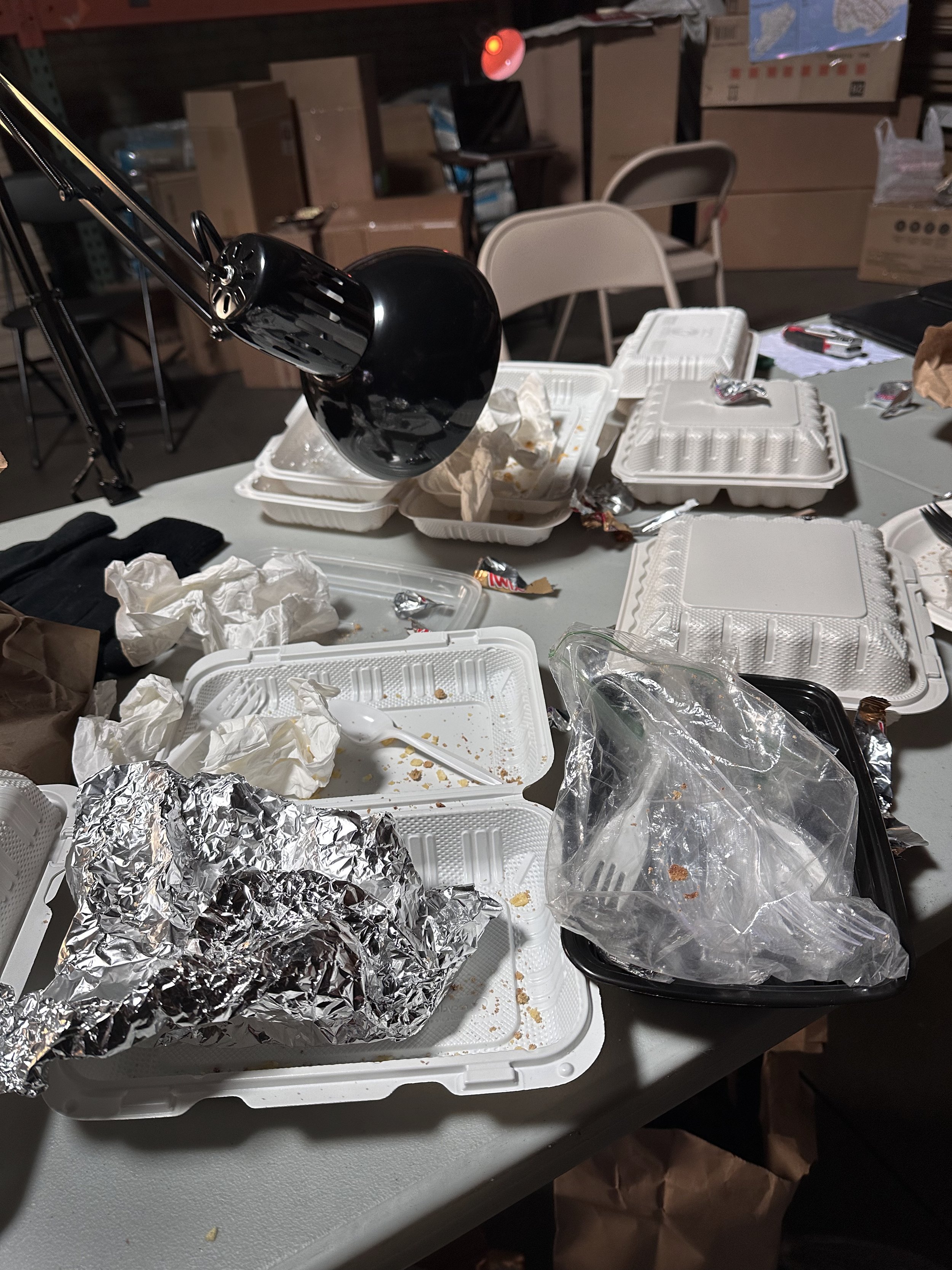 The set was constructed primarily from recycled and found materials. Discarded cardboard boxes, packing materials, and free takeaway containers were sourced and repurposed to create layered set dressing and practical prop elements. Material reuse was