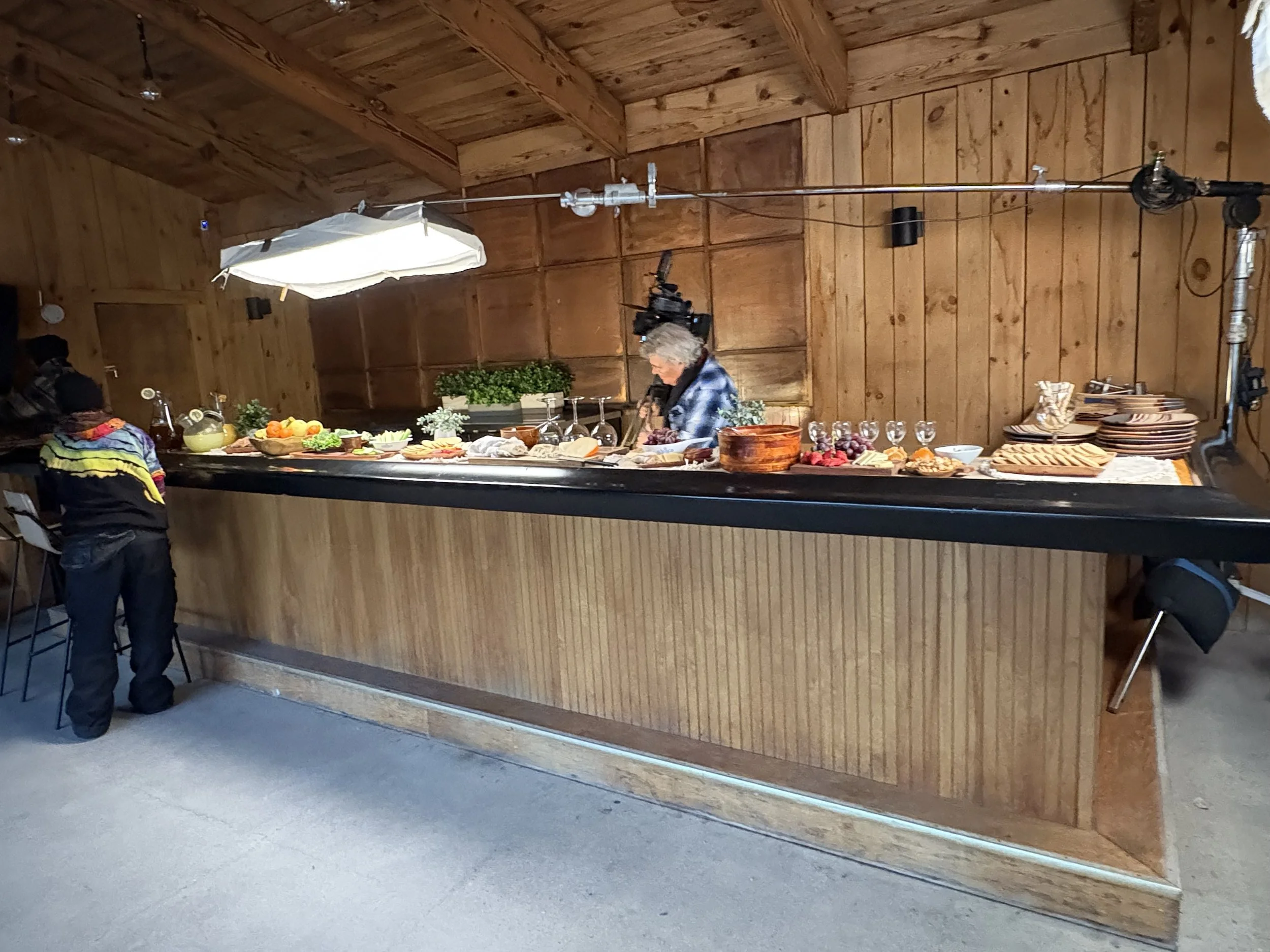 Luxurious buffet spread dressed along ski-lodge bar. 