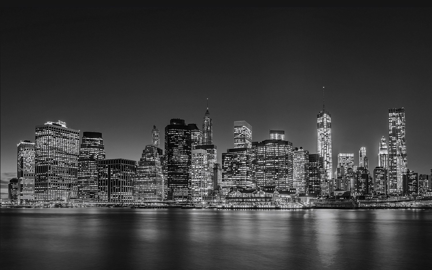 Lower Manhattan skyline at night, seen across the East River