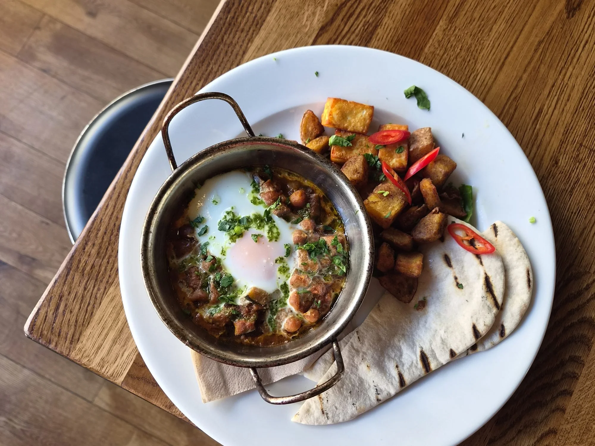 Lebanese breakfast at The Left Bank: shakshuka with a baked egg and chickpeas, fried halloumi, batata harra and grilled pitta.