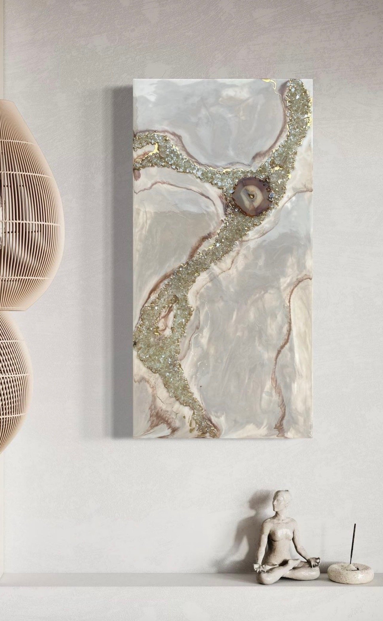 A modern minimalist interior with a textured wall, a marble and gold abstract wall art, a woven beige lamp on the left, and a meditation sculpture with incense on the right.
