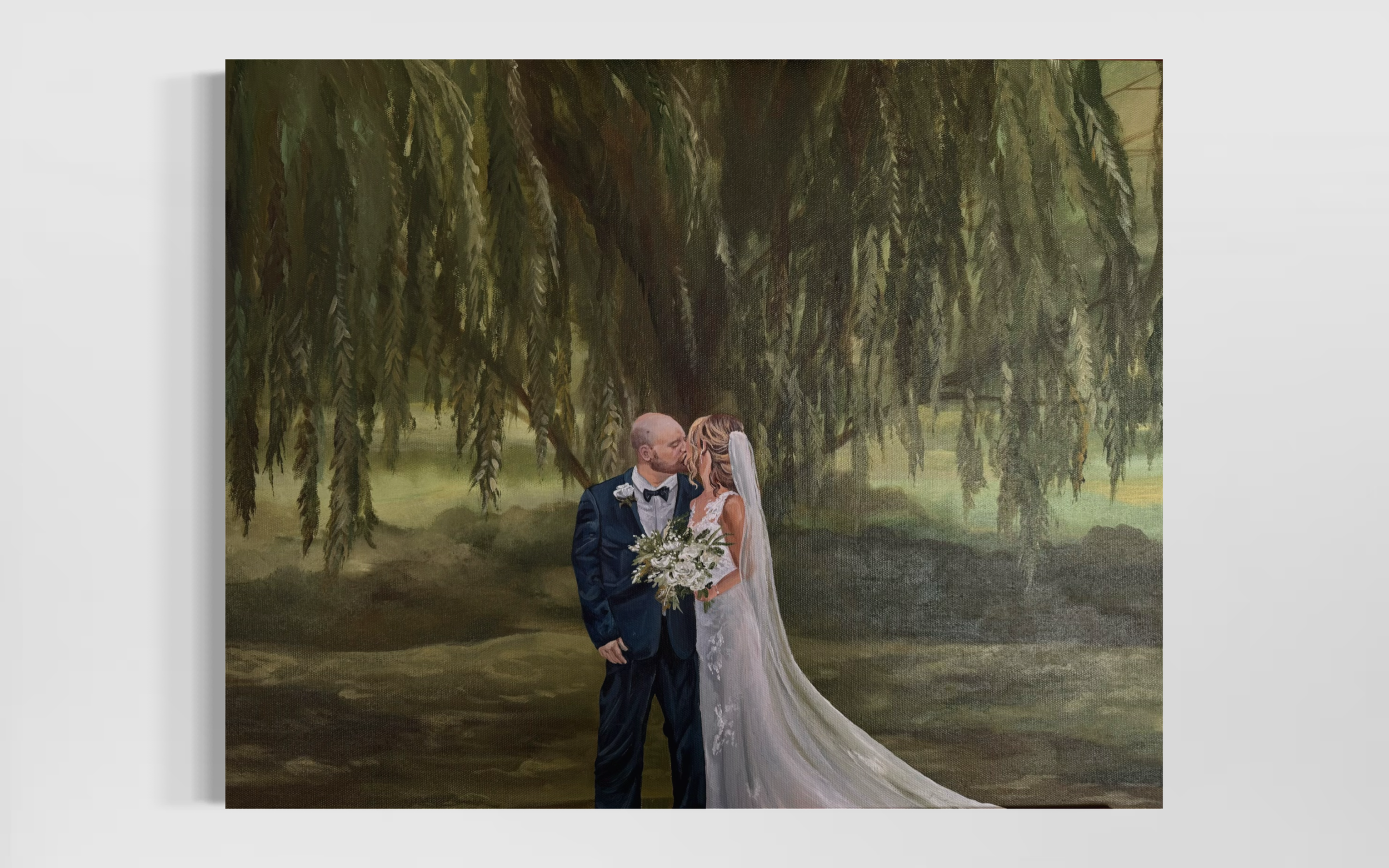 A bride and groom kissing under a large hanging tree with green foliage in the background.