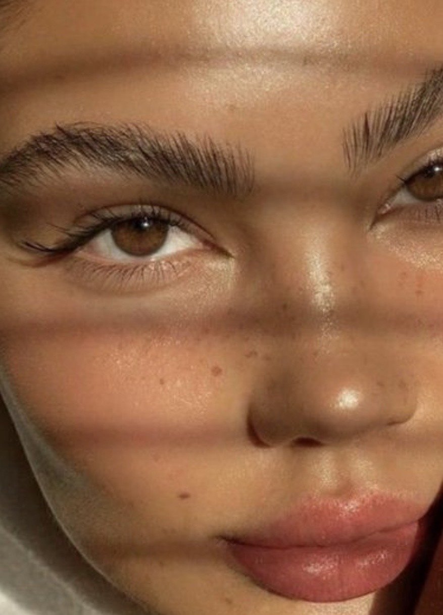 Close-up of a person's face, focusing on the left eye, nose, and lips, with natural skin texture and brown eyes.