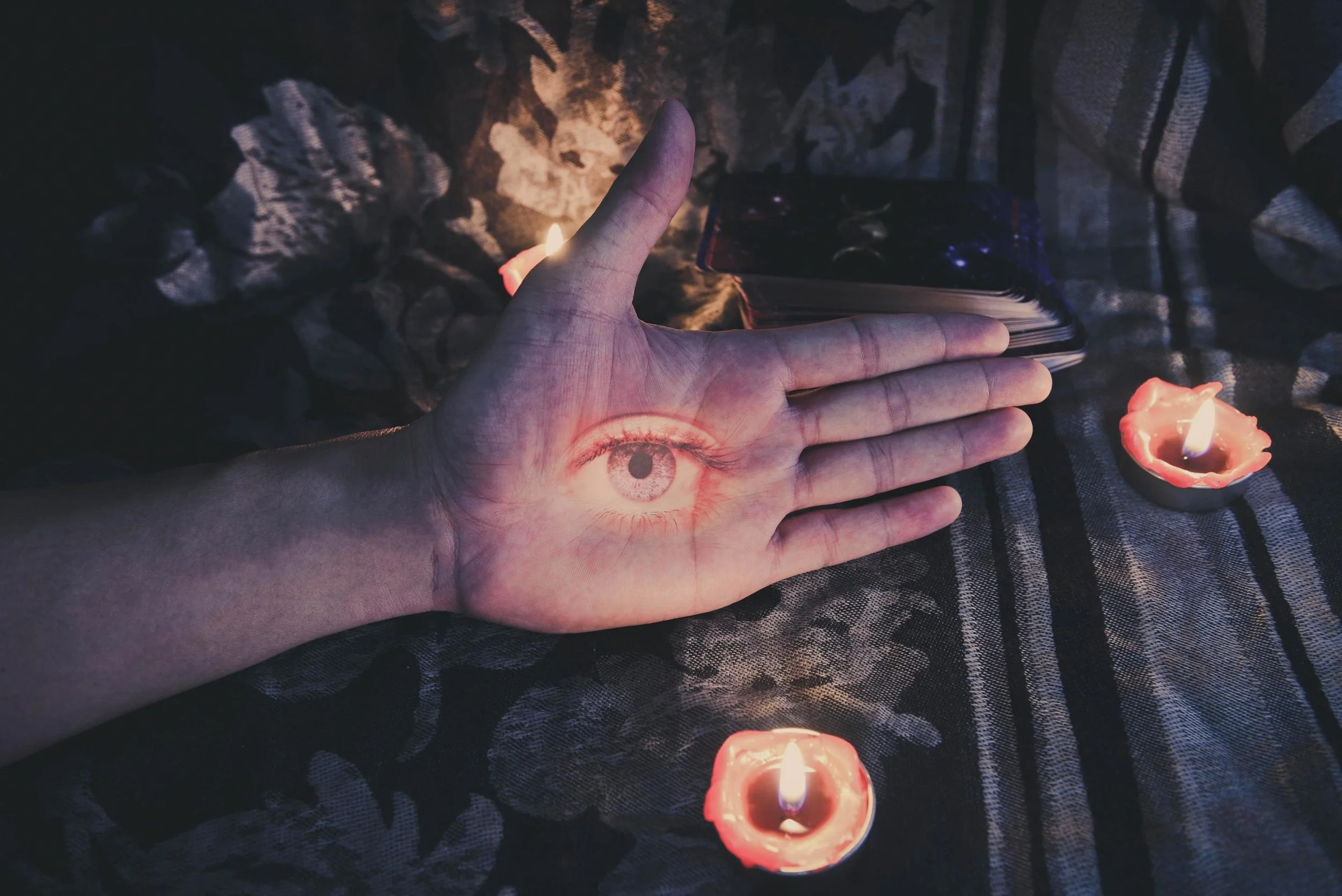 hand-with-the-eye-looking-for-astrology-occult-magic-illustration-and-candlelight-burning-candle-on-the-darkness-background-magic-spiritual-horoscopes-and-palm-reading-fortune-teller-concept-free-photo.jpg