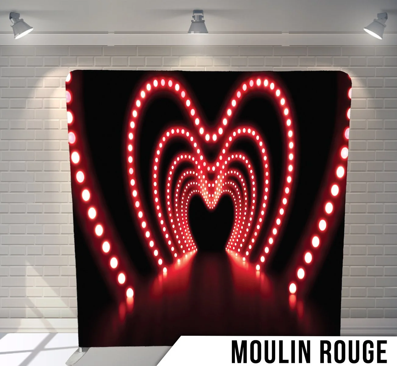 A photo of a photo backdrop with illuminated red heart shapes in a tunnel design, labeled 'Moulin Rouge' at the bottom.