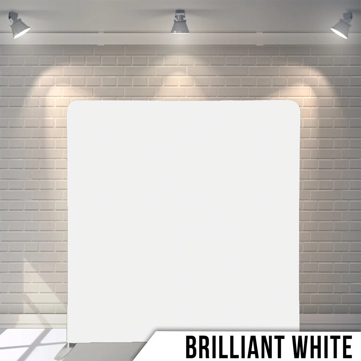 Blank white display board in a well-lit room with spotlights on a brick wall background, labeled 'Brilliant White'.