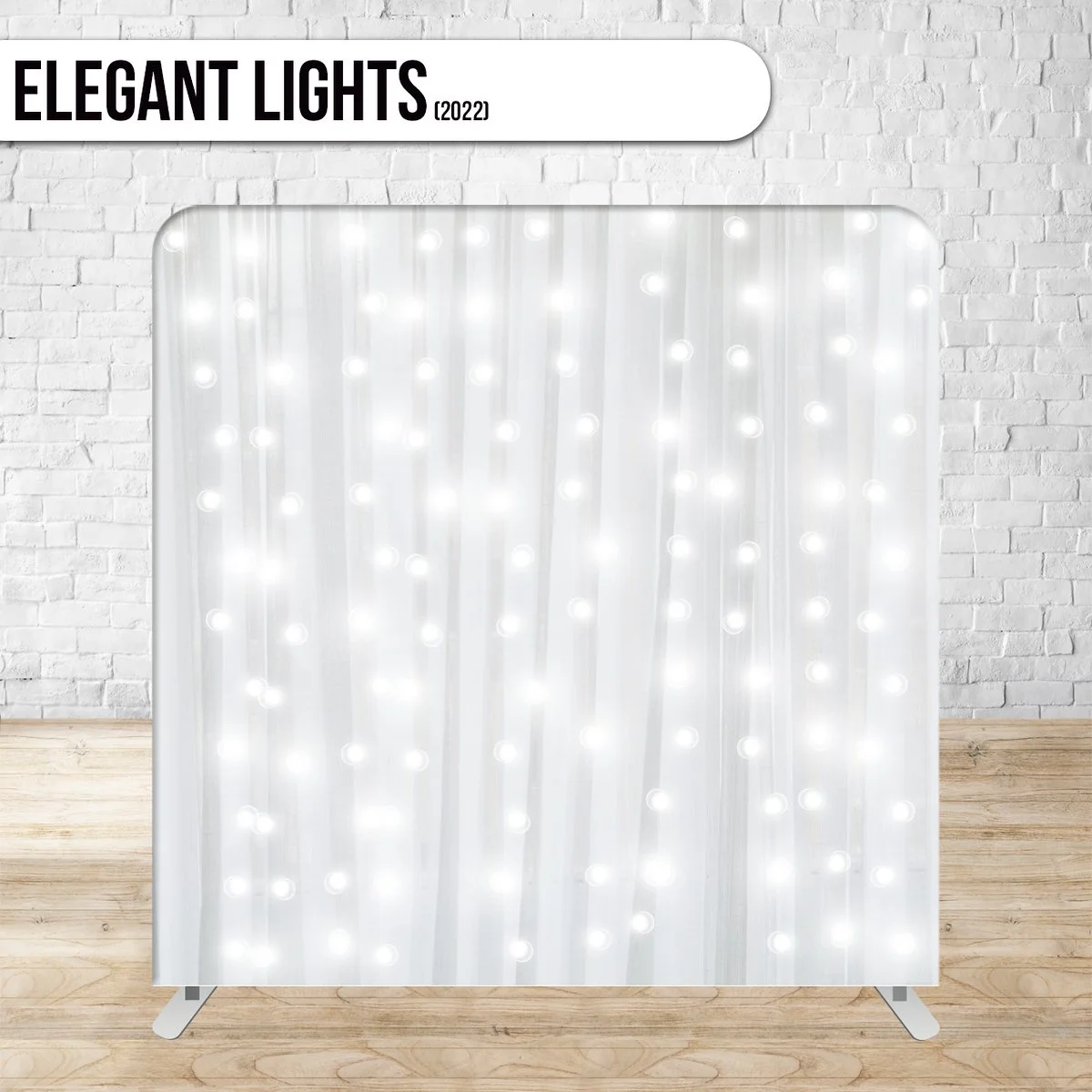 White curtain with vertical strings of small white LED lights hanging in front of a white brick wall and placed on light wood flooring.