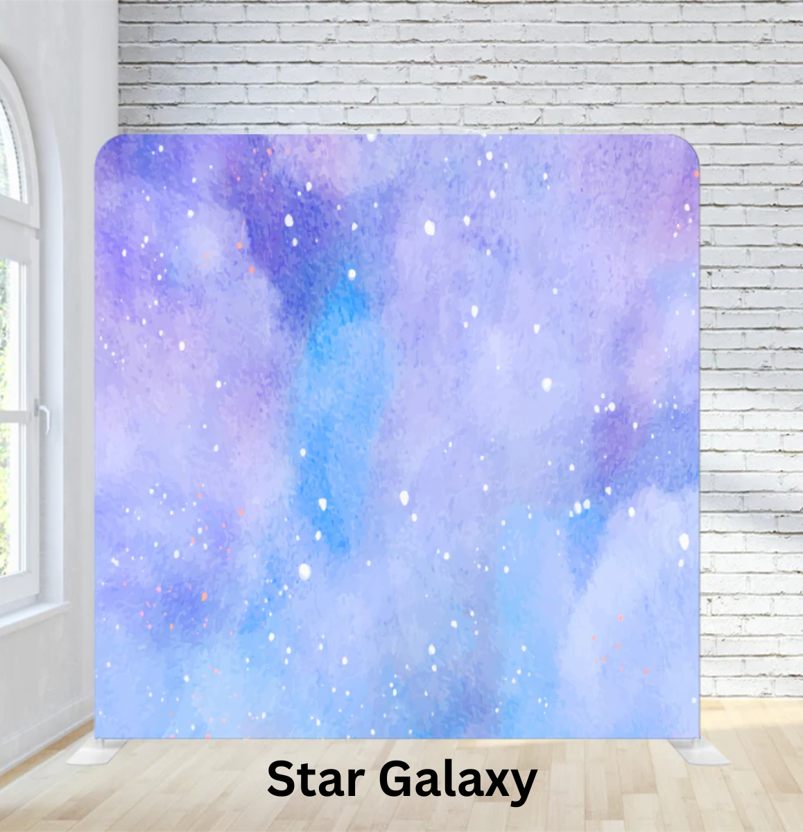 A star galaxy-themed fabric or backdrop with shades of purple and blue, speckled with white and orange spots, set against a white brick wall in a bright room.