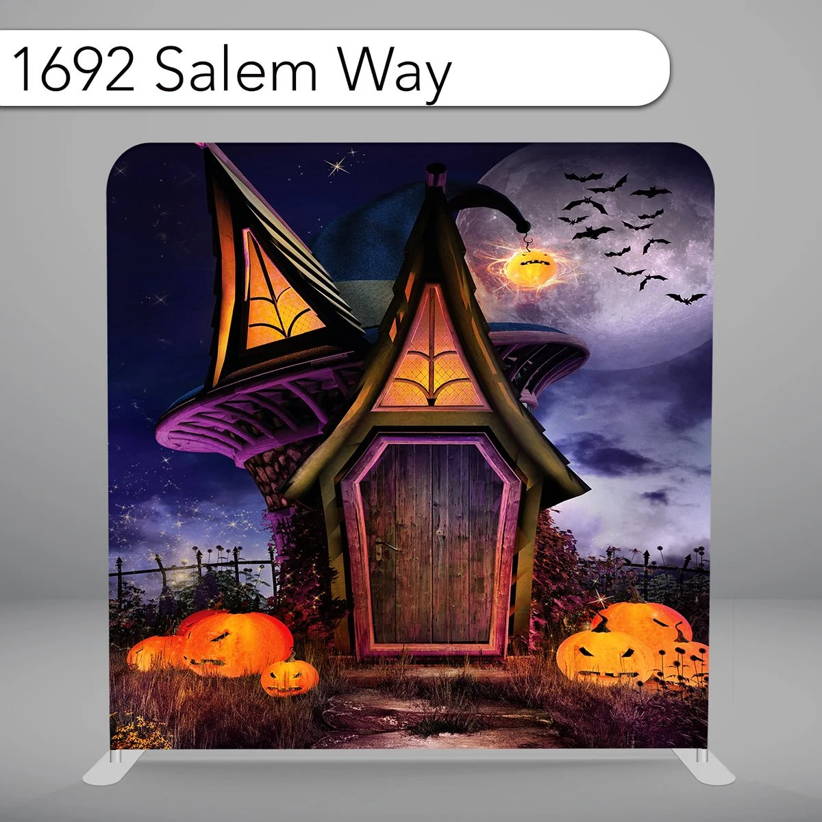 Spooky Halloween scene with a wooden haunted house, glowing jack-o'-lanterns on the grass, a full moon, a witch's hat on the roof, bats flying in the night sky, and a purple moon with clouds.
