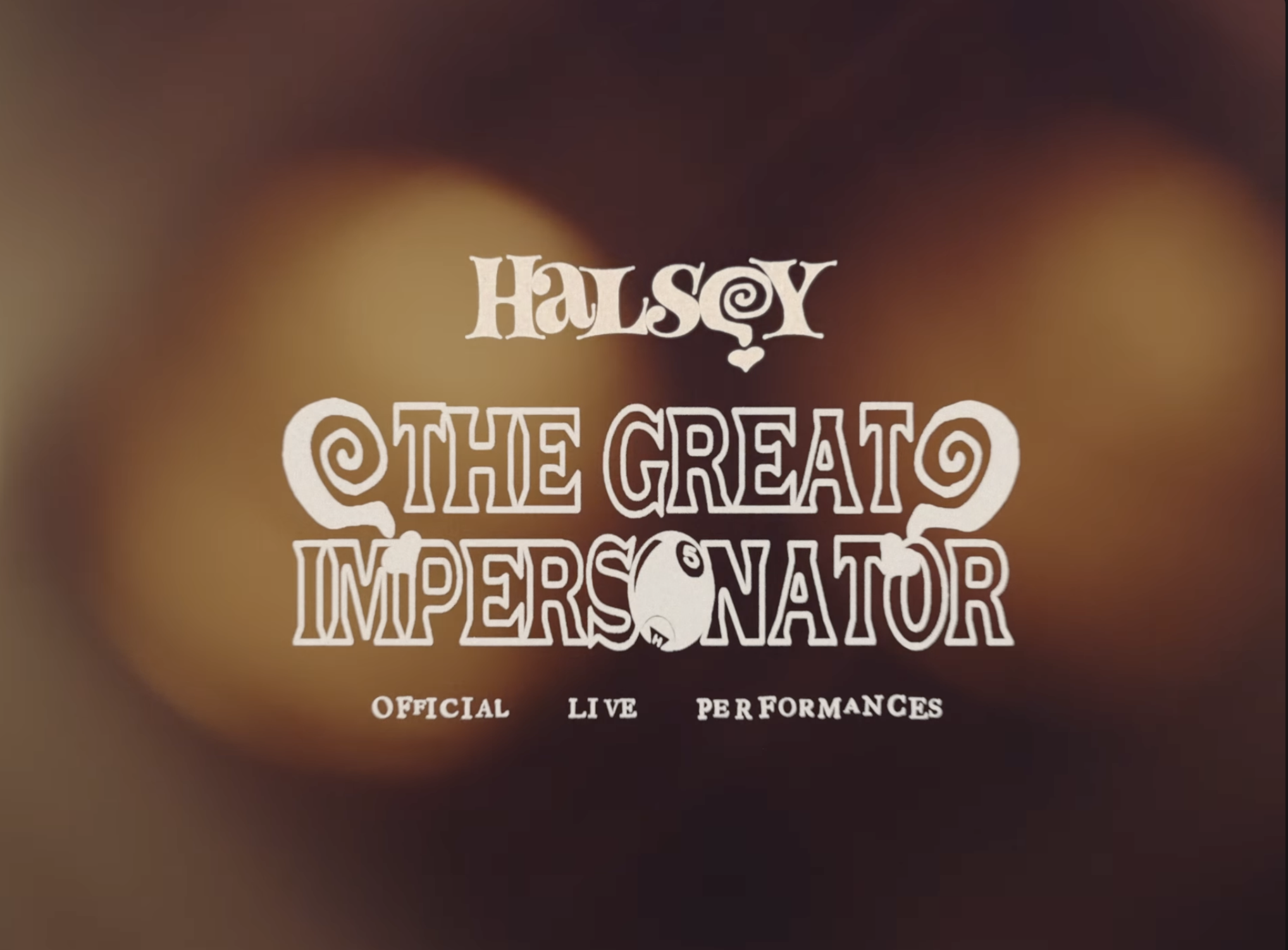 Title screen for Halsey's 'The Great Impersonator' with the text 'Official Live Performances' below, displayed over a blurred warm-toned background.