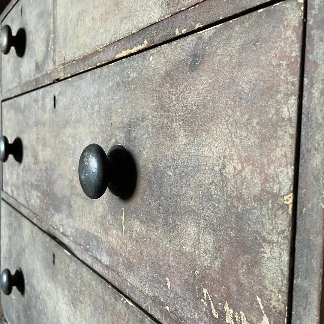 Close-up of a Victorian pine chest of drawers with its original paint and turned knobs, showing signs of wear and age. Bring It Home Furniture, Hingham Norfolk.
