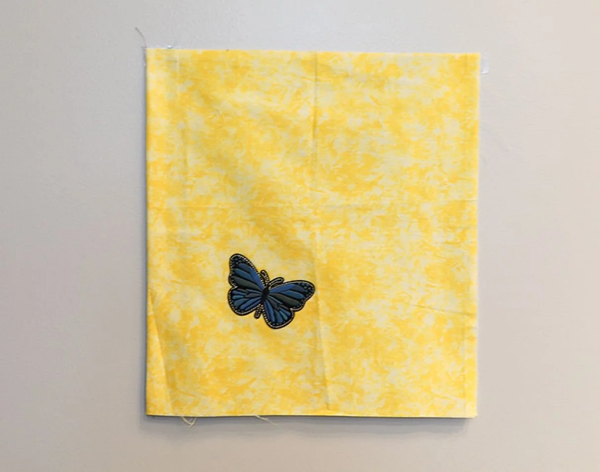 FLIGHT FOR PEACE
There is a simple, striking beauty as a lone blue butterfly takes flight against a pale yellow backdrop. In its wings are the colors of Ukraine, carrying a message of hope and peace. As the universal symbol for survivors of abuse, th