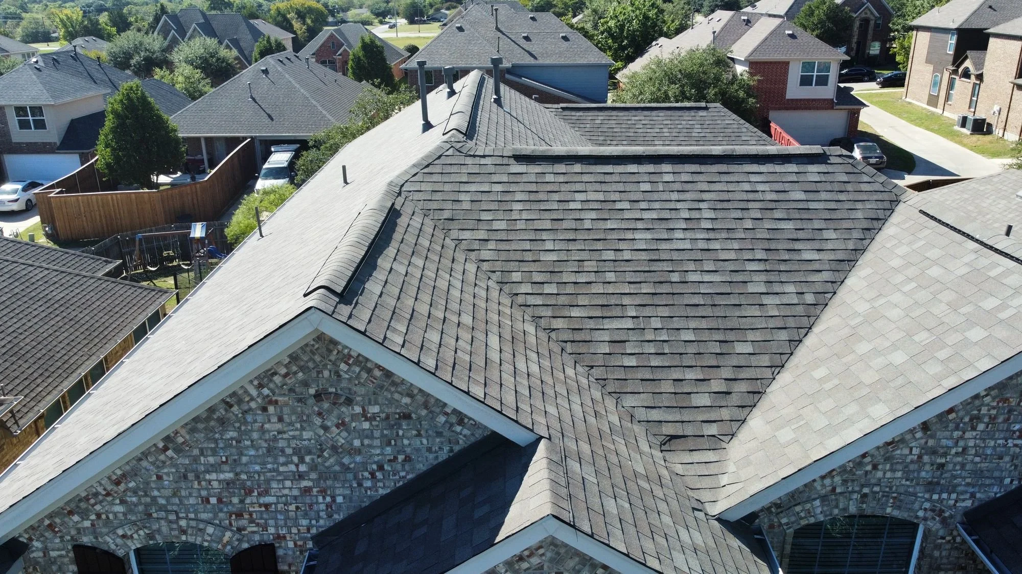 Aerial view of a new shingle roof by Christian Brothers Roofing in North Texas