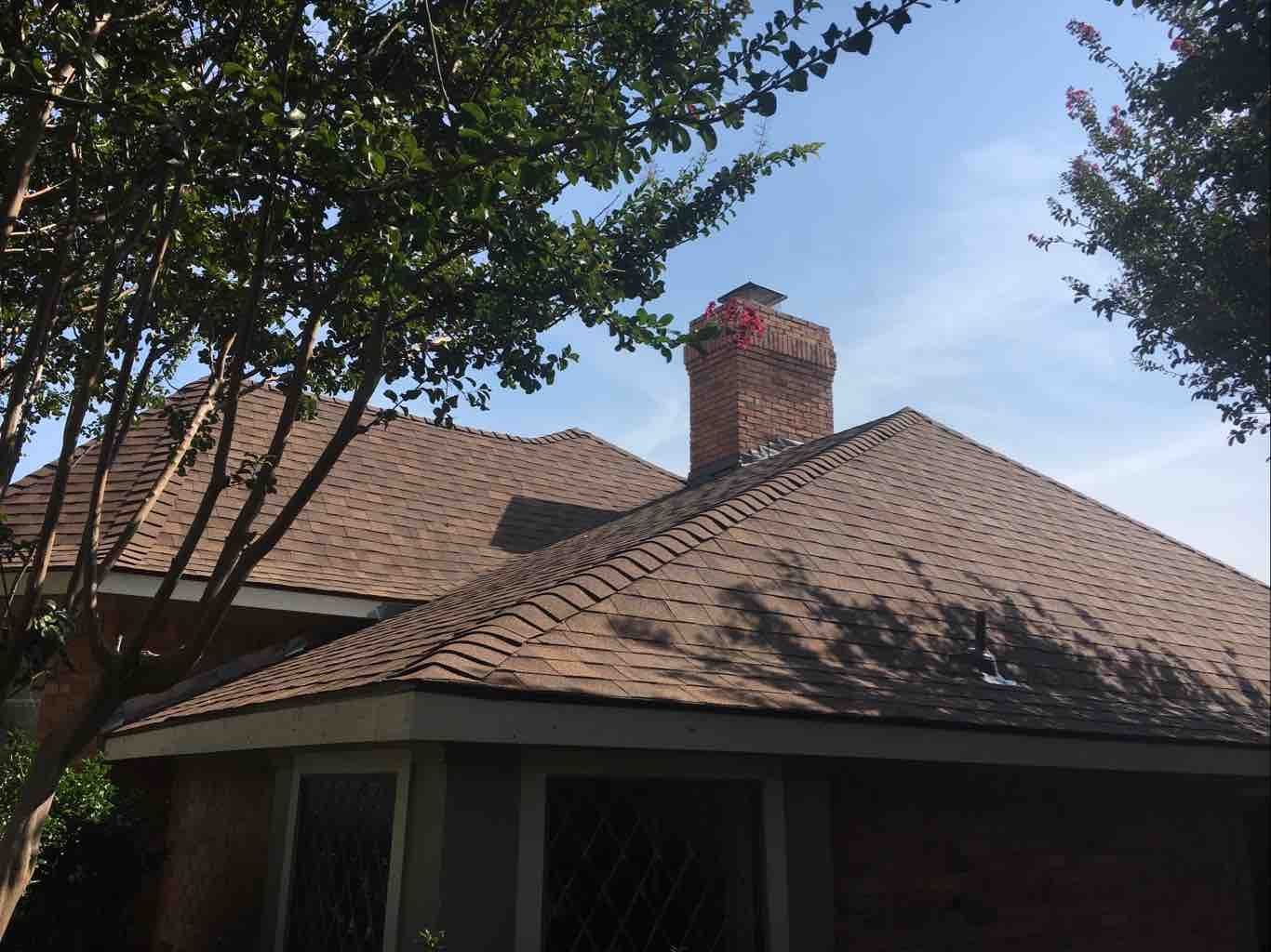 Brick home with a hip roof replaced by Christian Brothers Roofing in North Texas