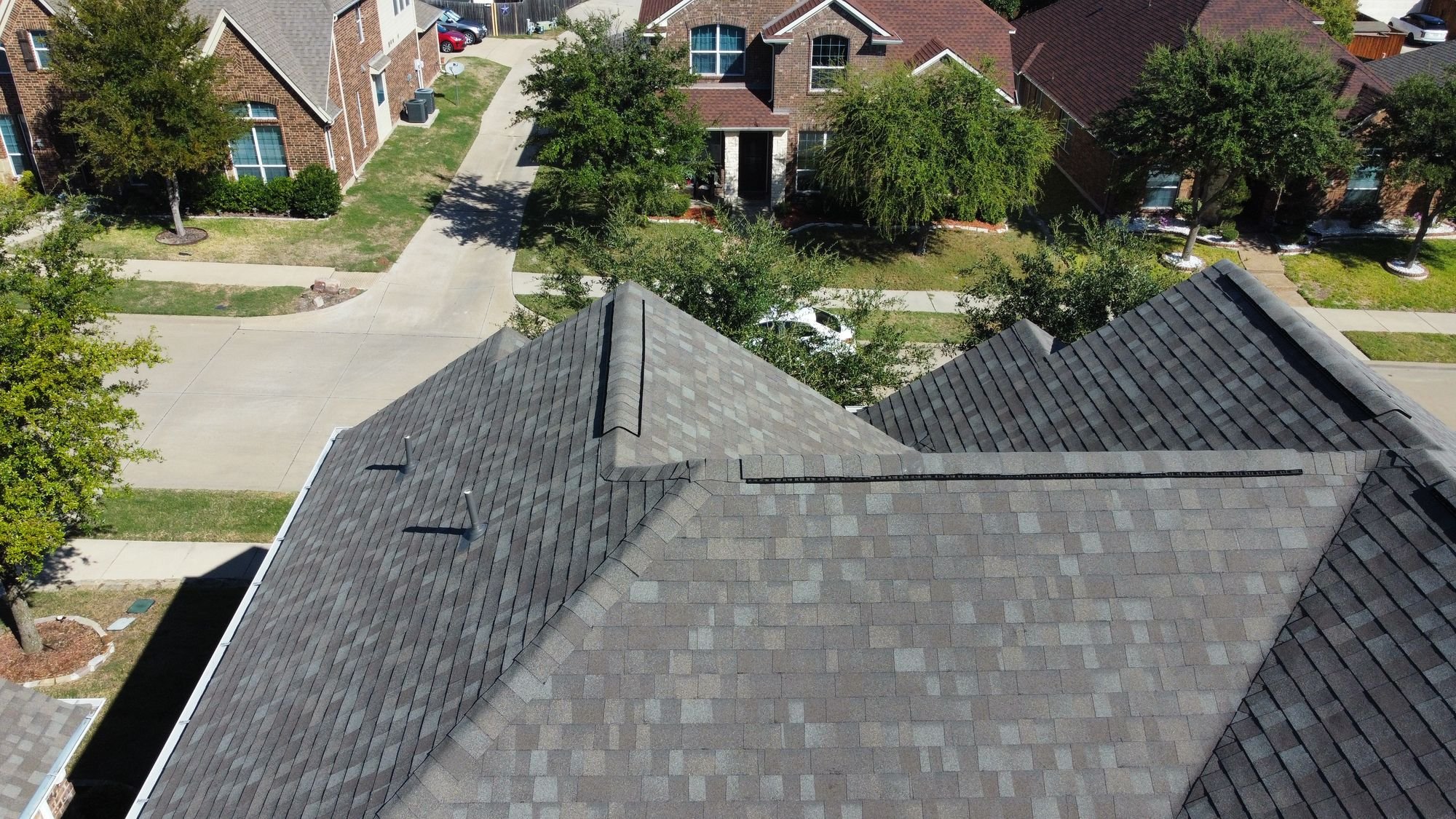 Aerial view of a new gray shingle roof by Christian Brothers Roofing in North Texas