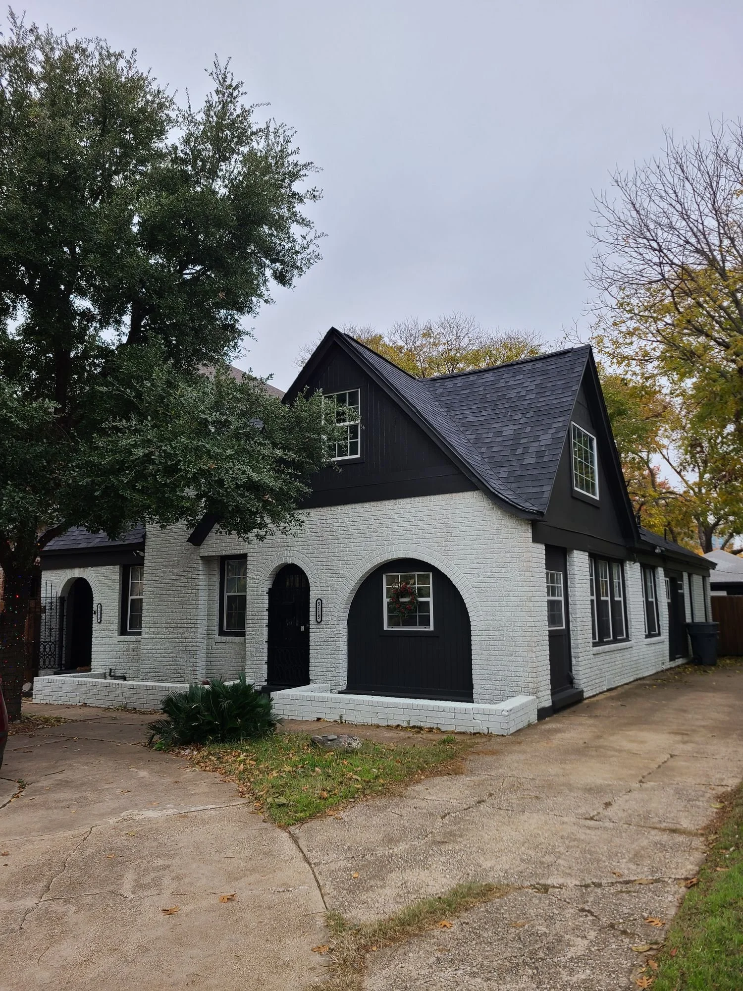 Black and white home with a new roof by Christian Brothers Roofing in North Texas