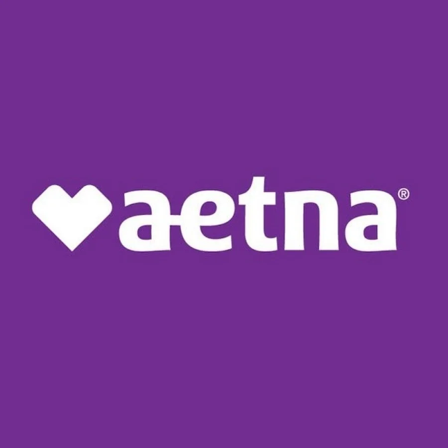 A purple background with the white logo of Aetna, including a stylized heart and the word "aetna" in lowercase letters.
