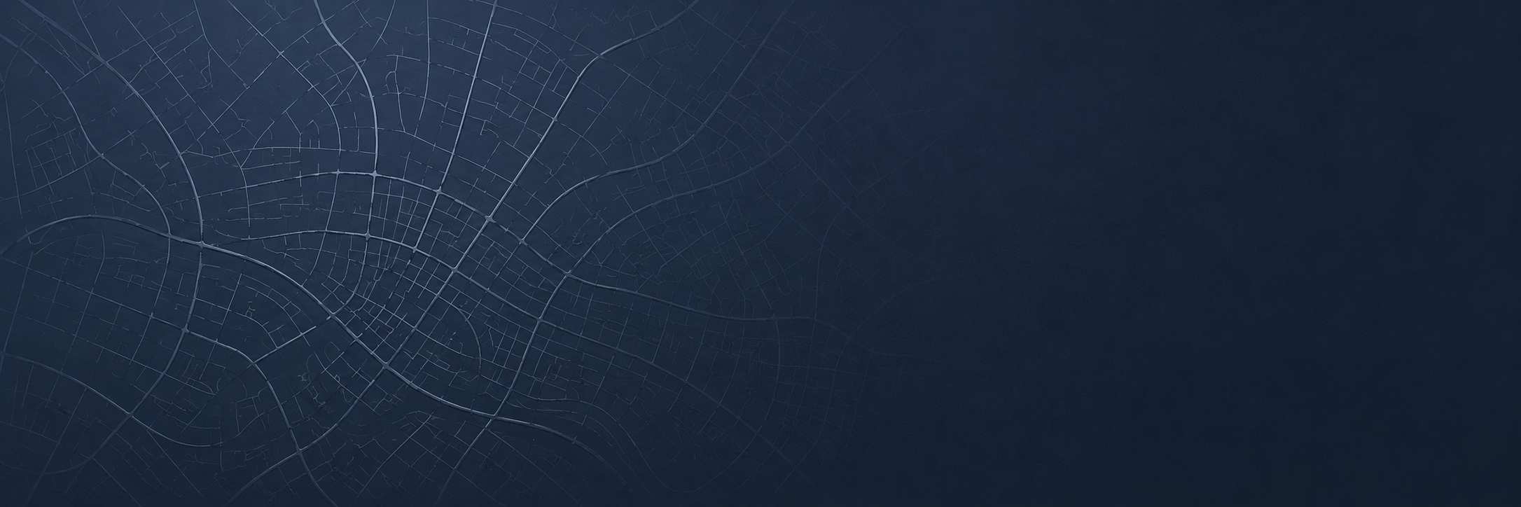 Dark city map with streets and roads outlined in light lines on a dark background.