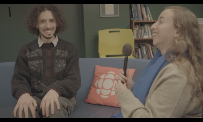 Hannah is interviewing Dre on a couch at CBC