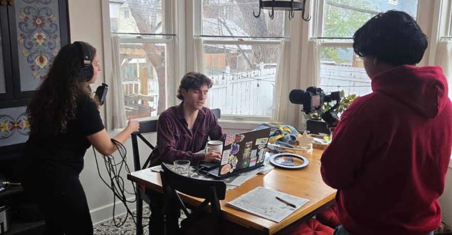 Hannah and her film crew filming someone on their laptop for a scene