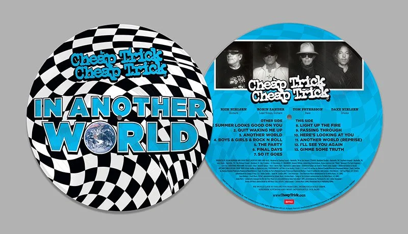 A vinyl record with a checkered black and white background. The label features the band name 'Cheapo Trick Cheapo Trick' and the album title 'In Another World.' The tracklist is also visible, mentioning songs like 'Light Up the Fire' and 'Gimme Some Truth.'