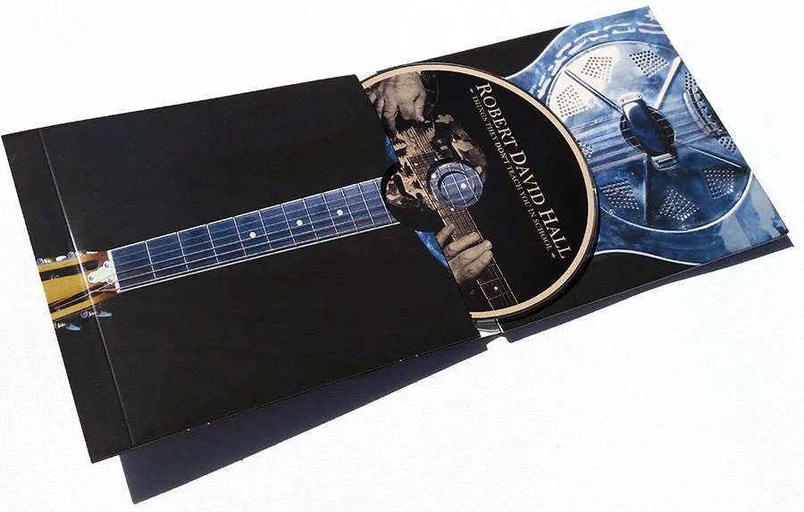 A Guitar-shaped CD holder with an album cover and CD inside. The album is by Robert David Hall.