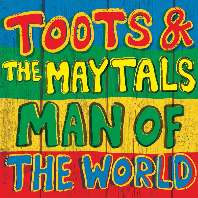 Colorful sign with the words "Toots & The Maytals Man of the World" in large, vibrant letters against a rainbow-colored background.