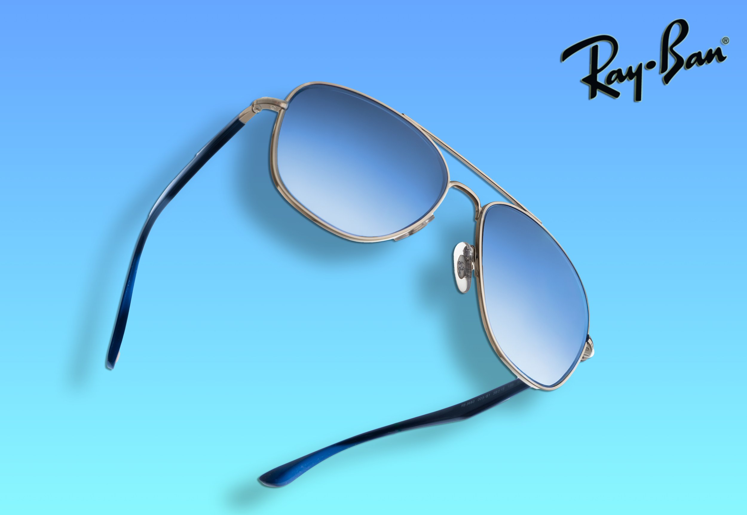 Ray-ban sun glasses on gradient blue background product photography