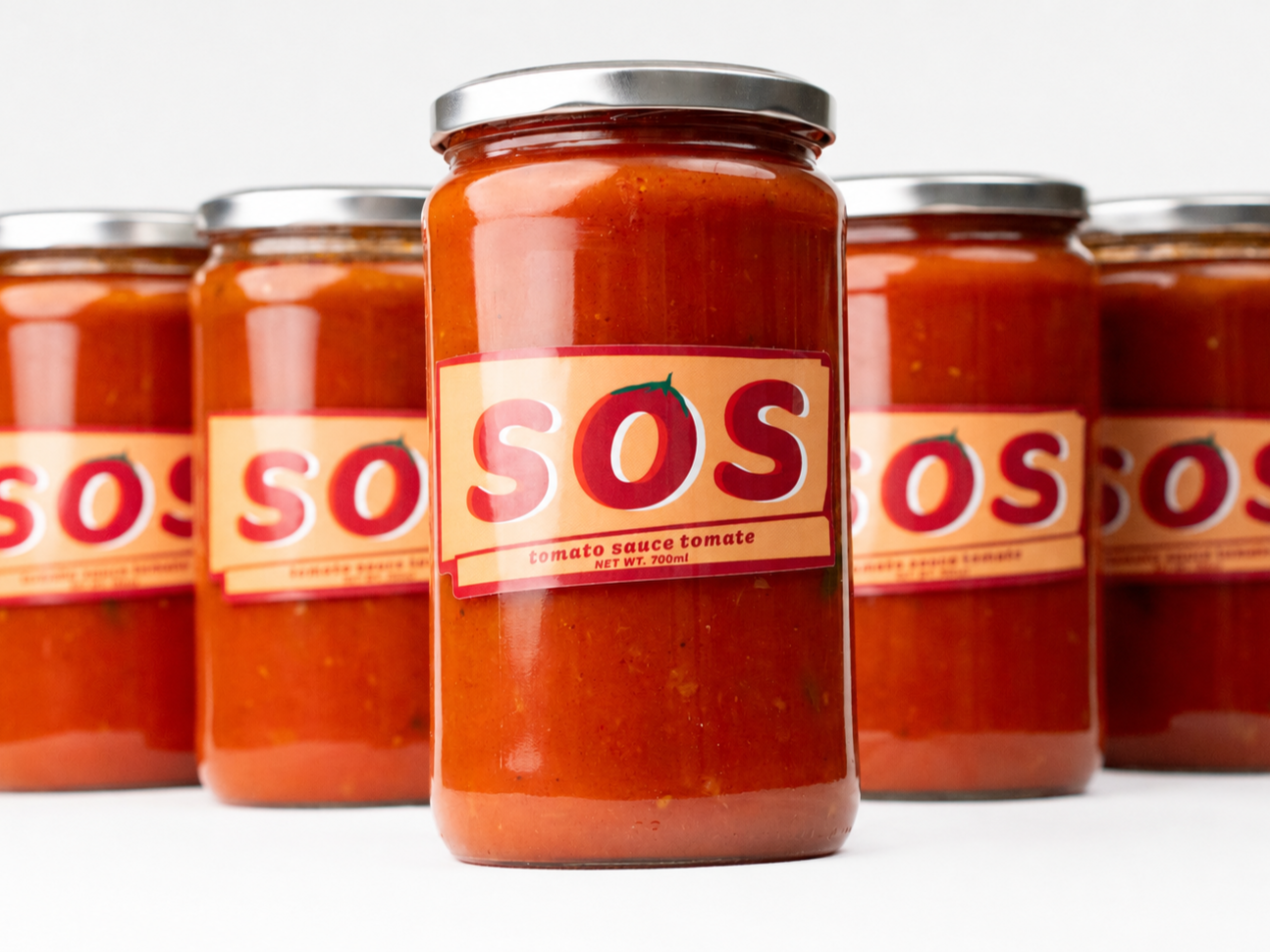Six jars of tomato sauce with labeled caps and labels reading 'SOS' and 'Tomato Sauce,' arranged on a white surface.
