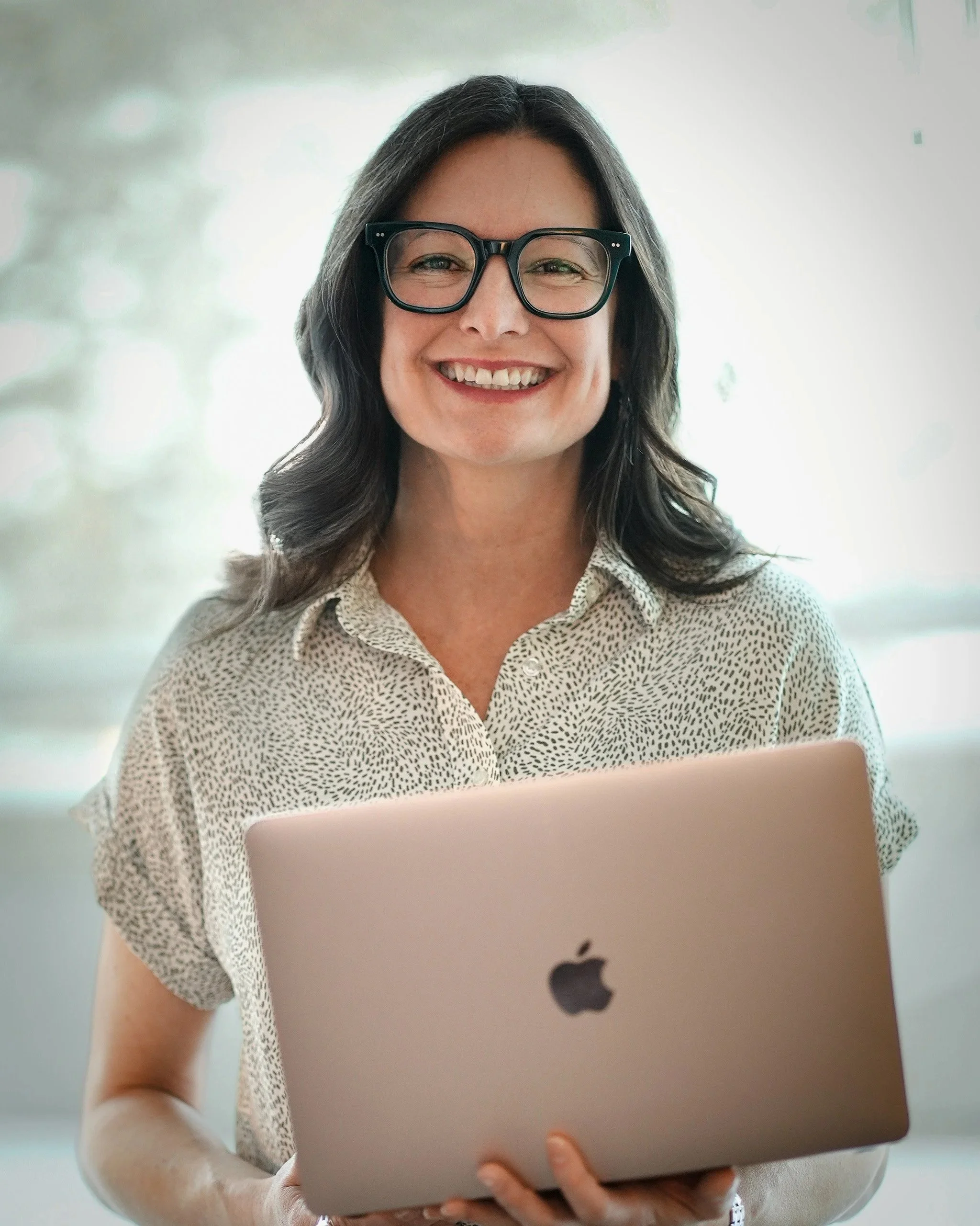 Smiling portrait of Lori Johnstone, Canopy & Co. Psychology owner, sharing her company’s mission