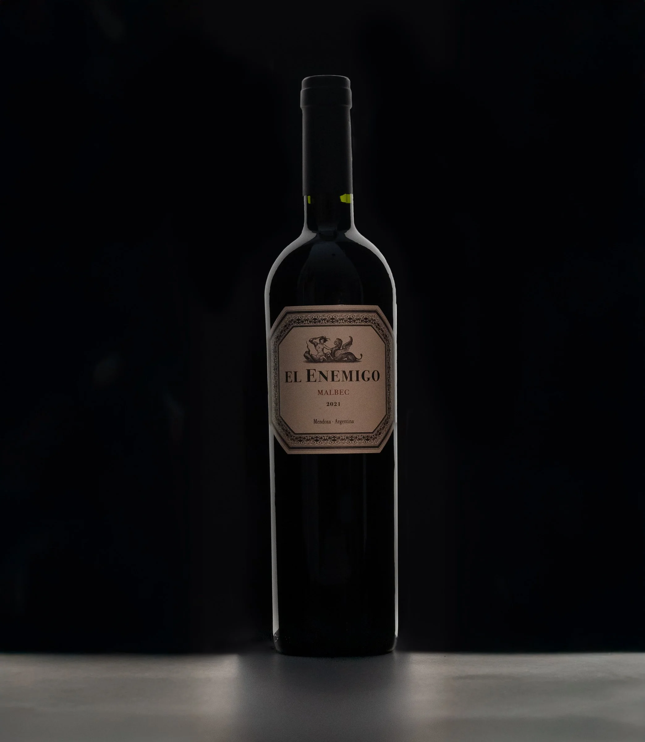 El Enemigo Malbec | Minimalist Wine Photography
Professional wine product photography featuring El Enemigo Malbec. This minimalist shot uses elegant rim lighting to define the bottle silhouette against a deep black background, highlighting the intric