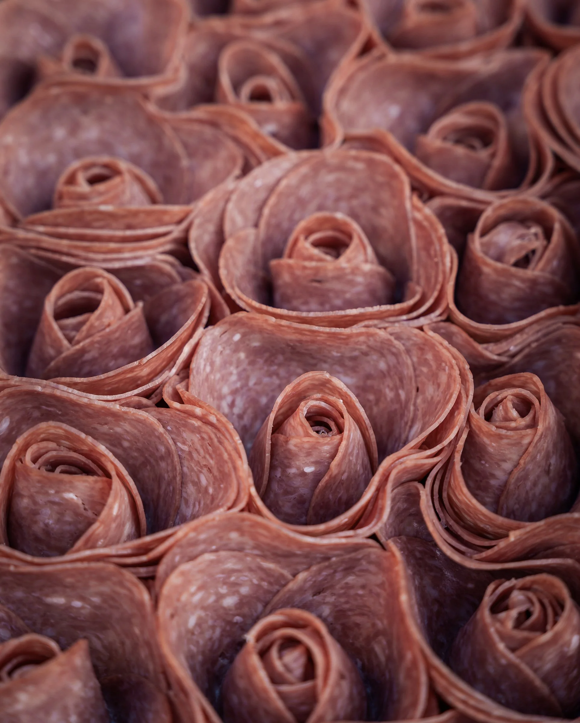 Salami Roses | Charcuterie & Meat Styling
Professional food photography of artisan salami roses. This editorial pattern study highlights delicate meat textures and professional charcuterie styling for luxury catering, restaurant branding, and gourmet